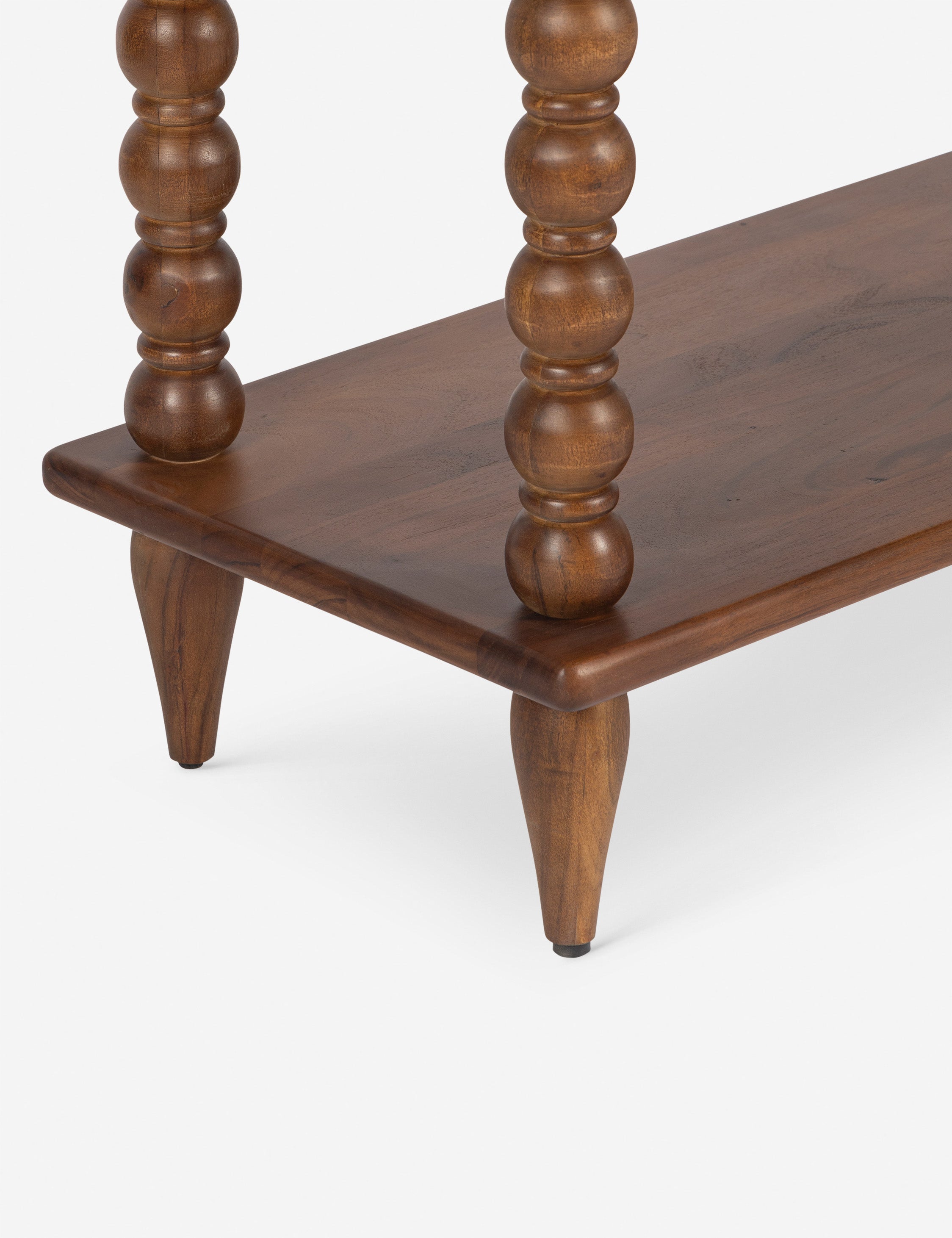Close up of the bottom shelf of the Foxton beaded turned wood tall bookcase