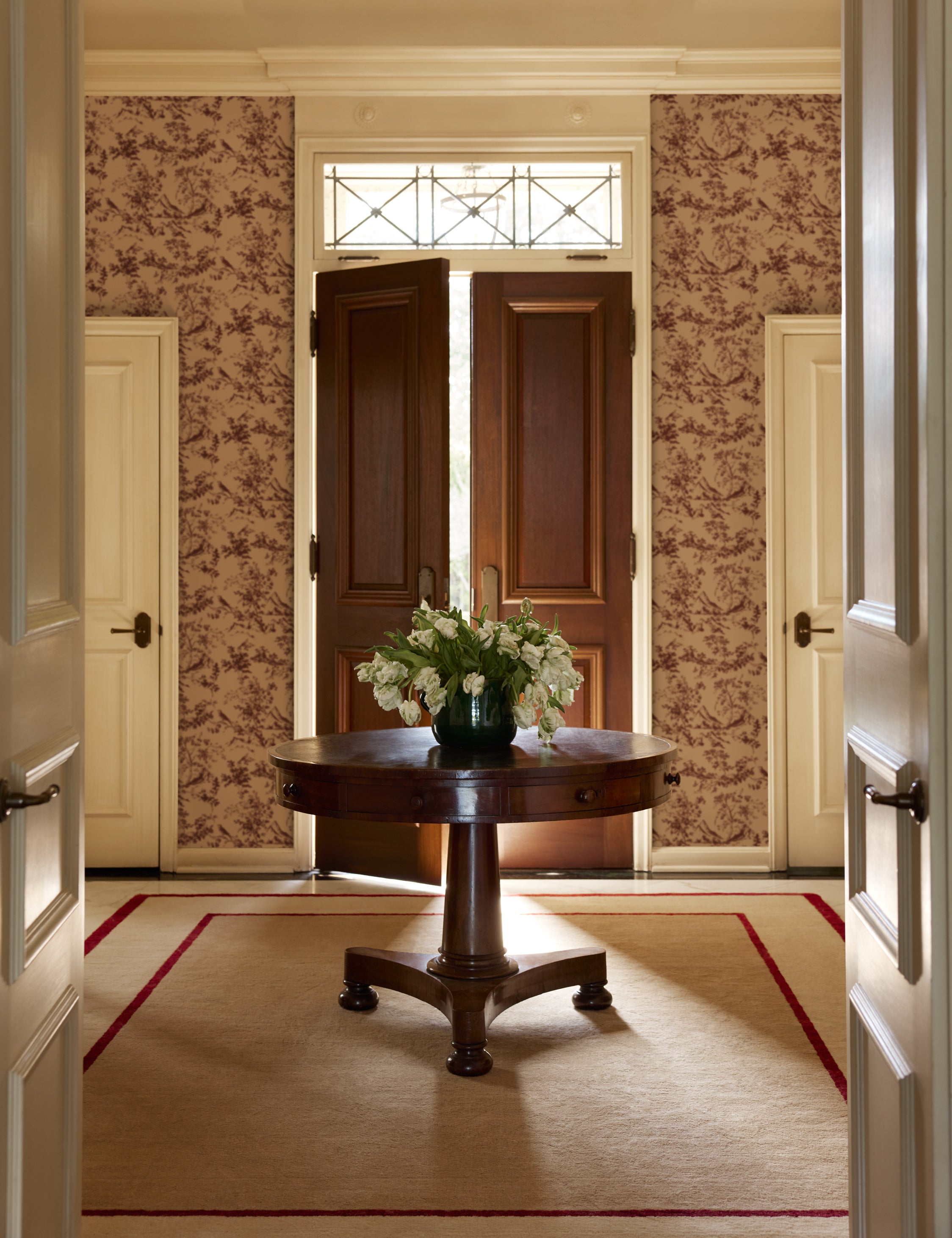 An entryway featuring the Deller Hand-Loomed Wool Rug by Jake Arnold