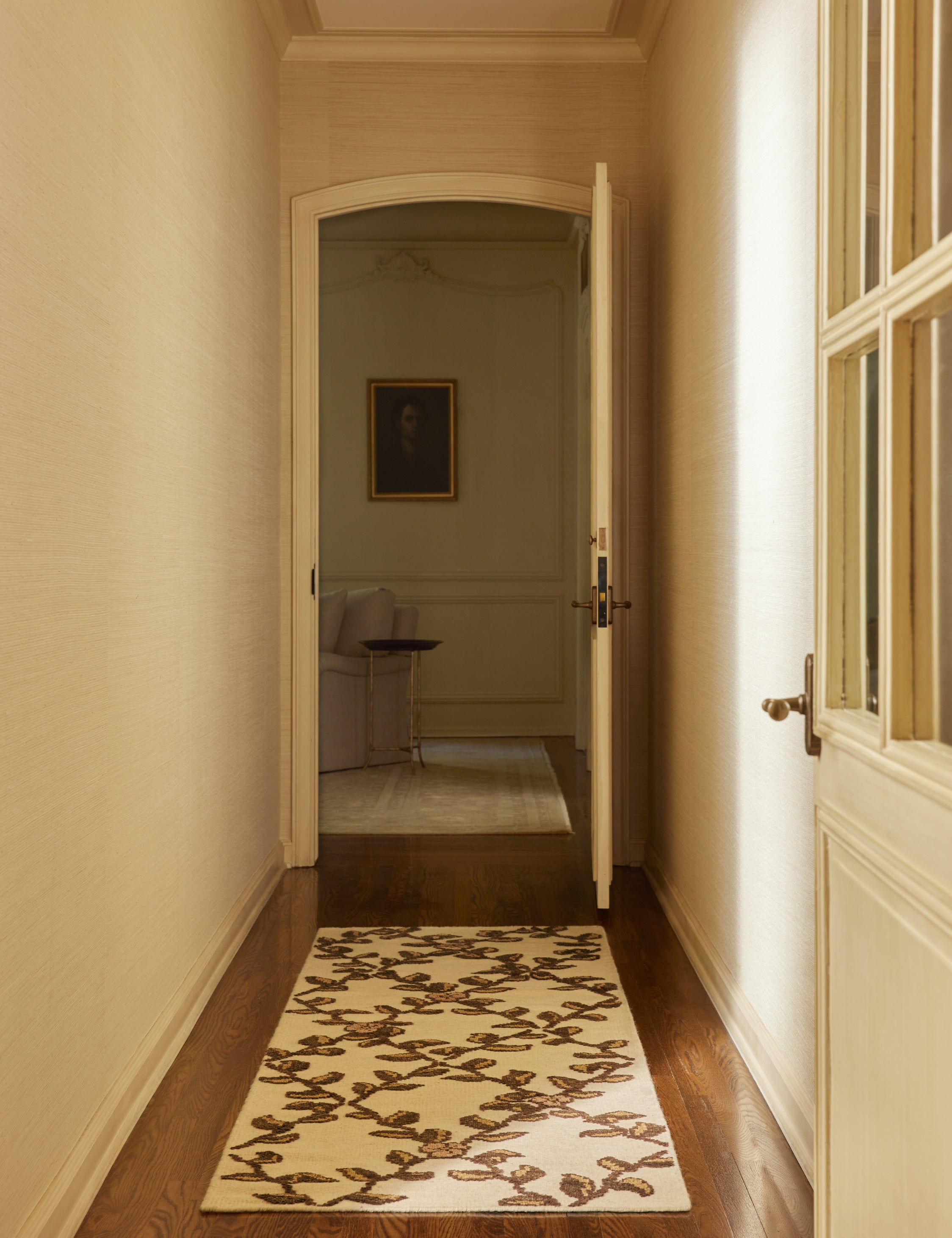 A hallway featuring the Tillar Hand-Knotted Botanical Lattice Wool Rug by Jake Arnold in the runner size.