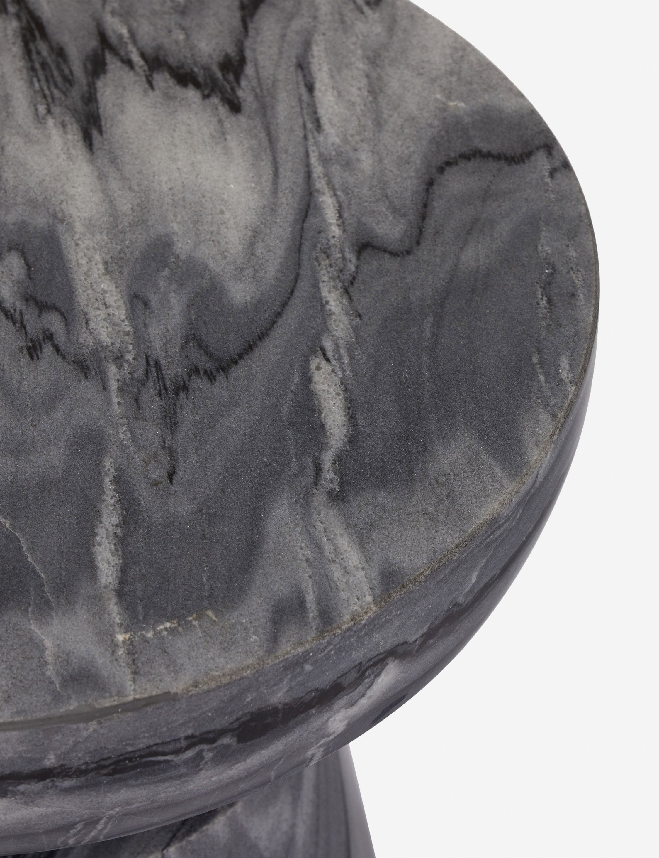Close up view of the Zeller round carved ebony marble side table.
