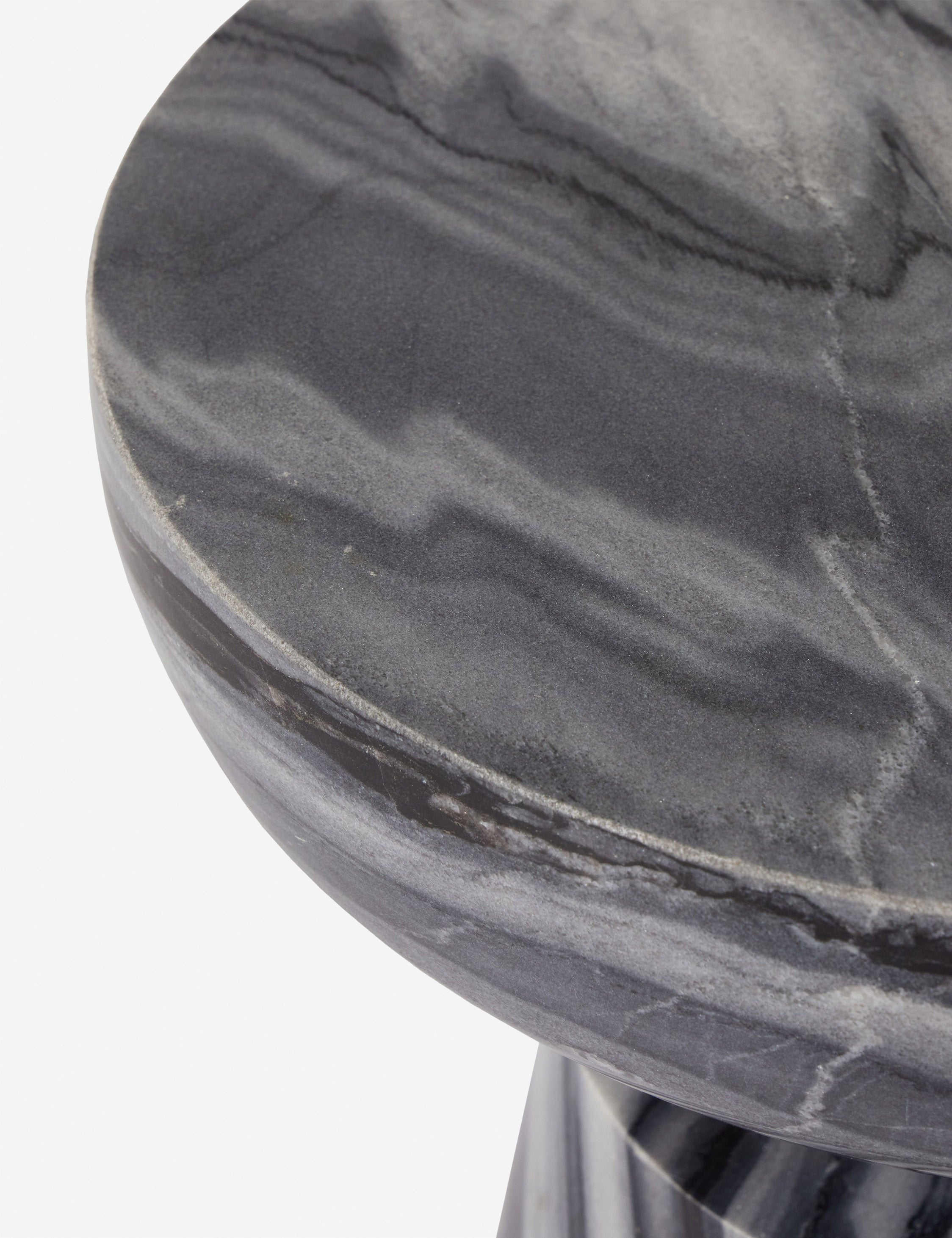 Close up view of the marble top of the Zeller round carved ebony marble side table.
