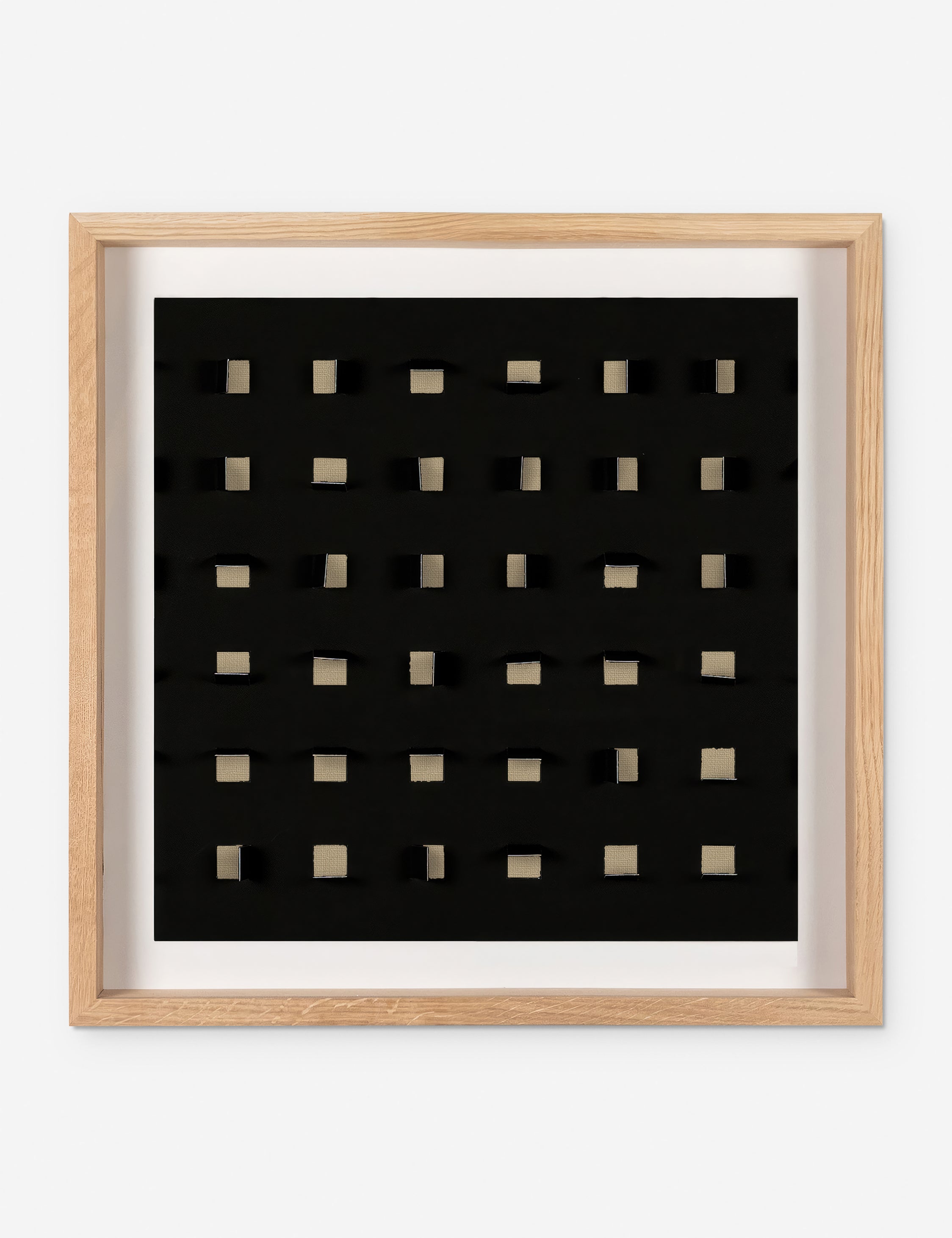 See Through small tan and black wall art featuring square paper cutouts with flaps on a linen backdrop