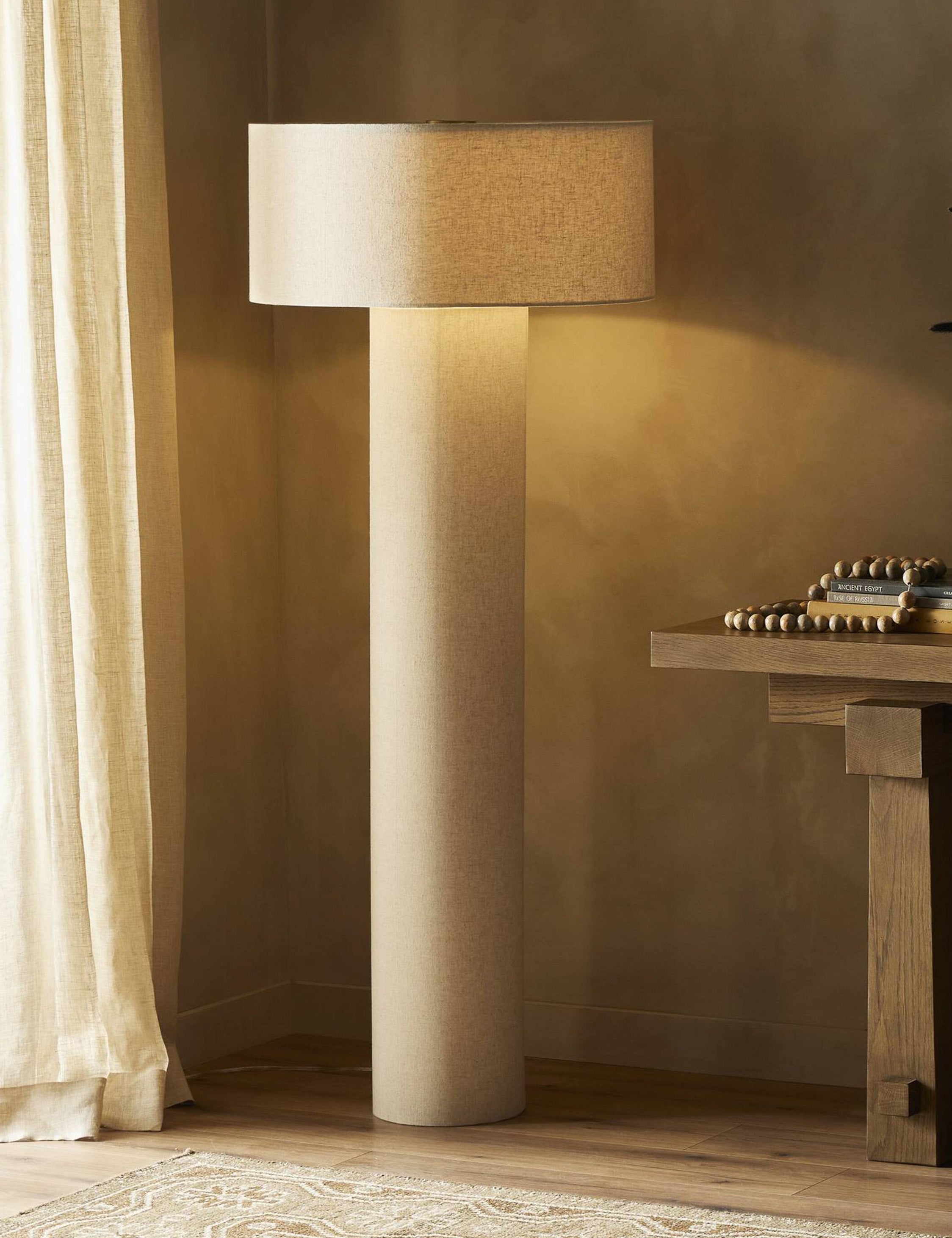 Solstice monochromatic linen column floor lamp styled next to a console table.