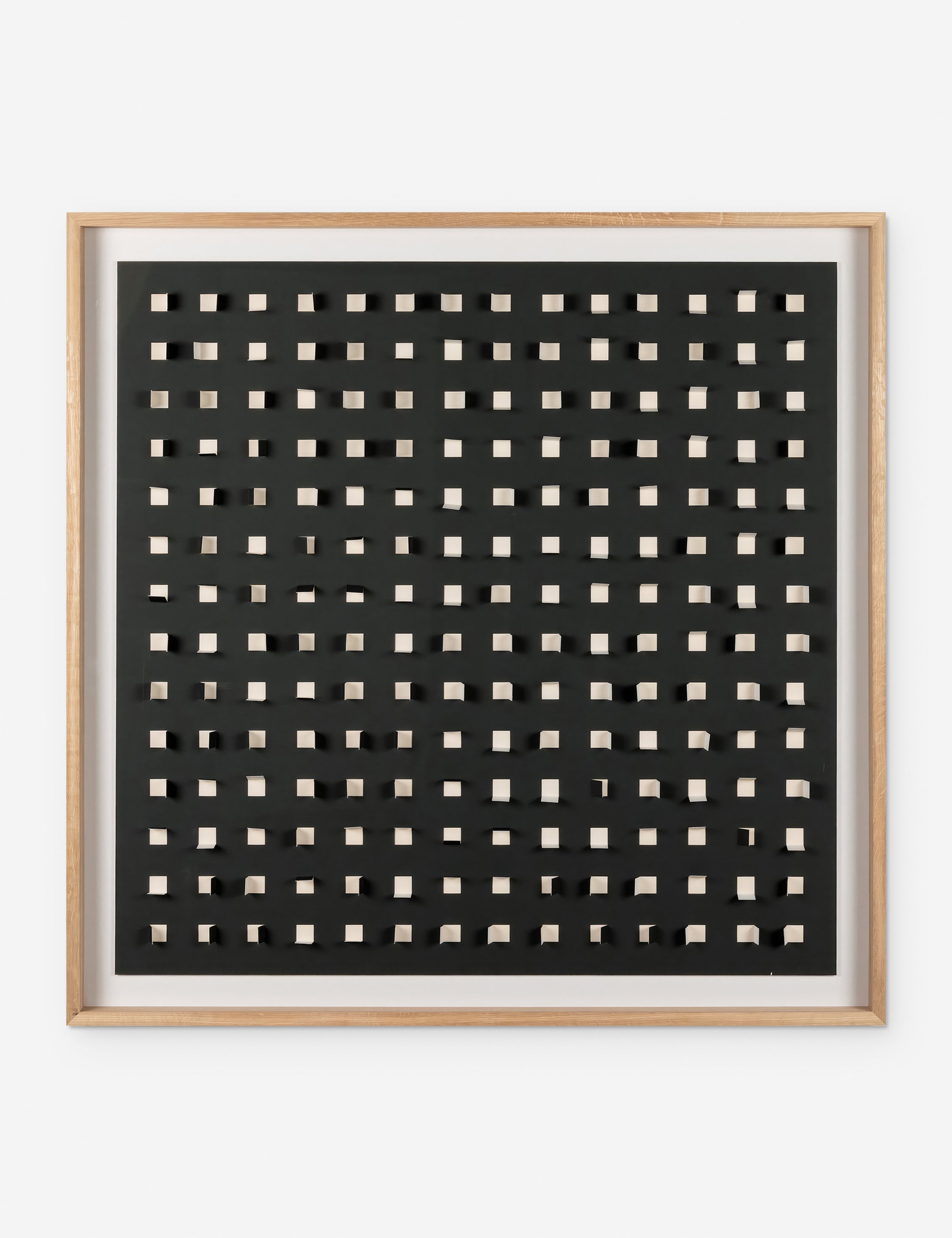 See Through black and white wall art featuring square paper cutouts with flaps on a linen backdrop
