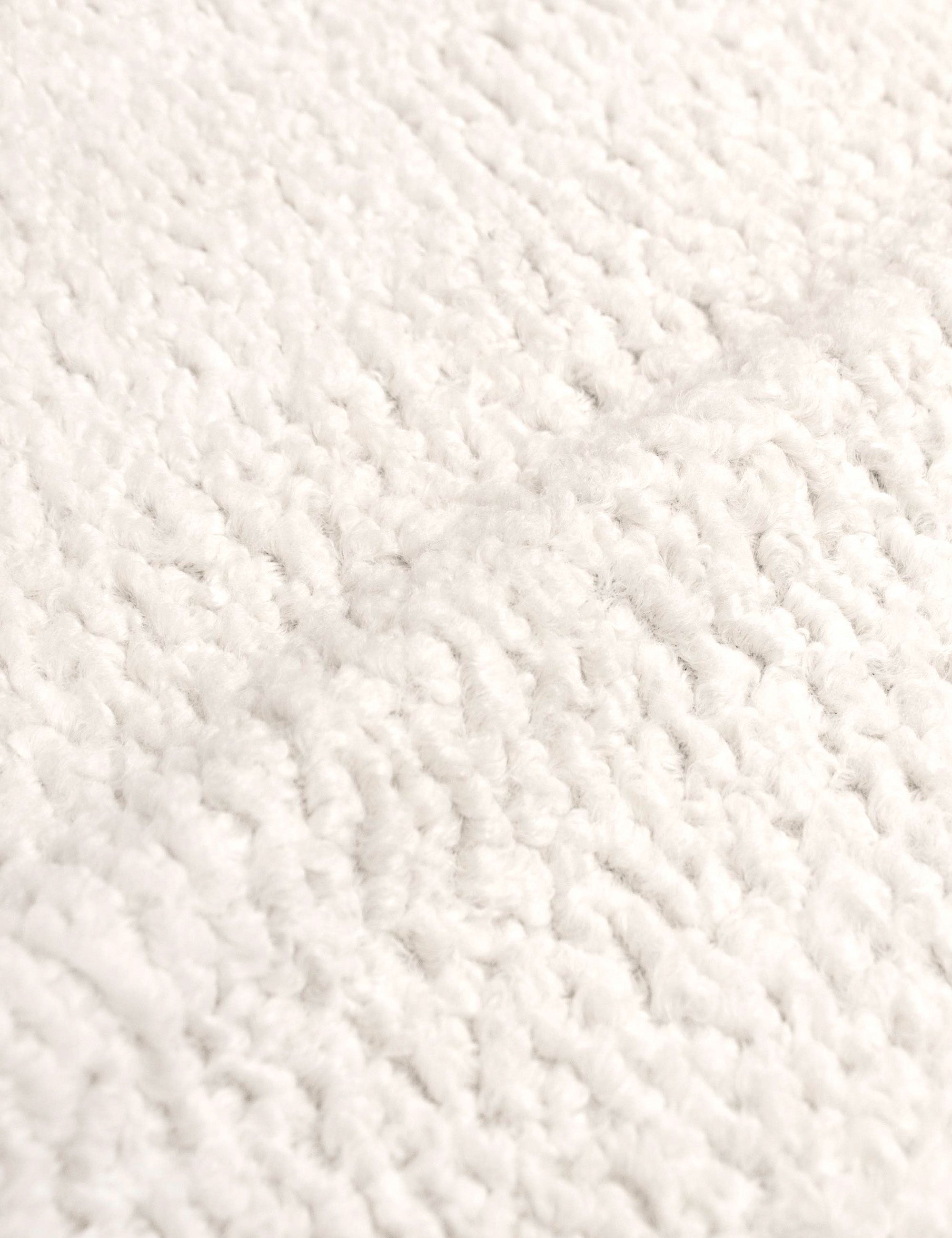Detailed shot of the boucle fabric on the Adara cream sherpa upholstered bed.