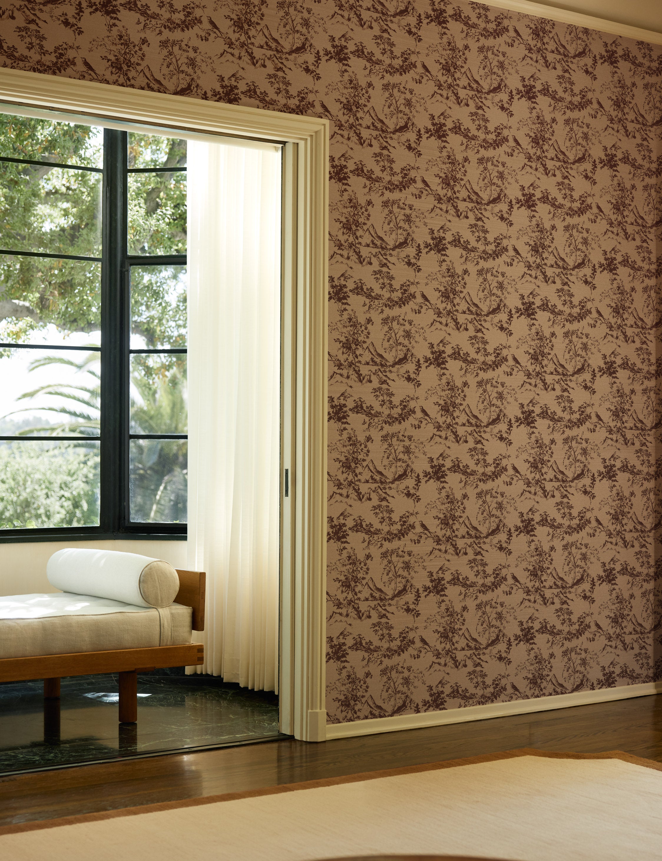 A room with a sitting nook with a bench featuring the Dors Grasscloth Wallpaper by Jake Arnold