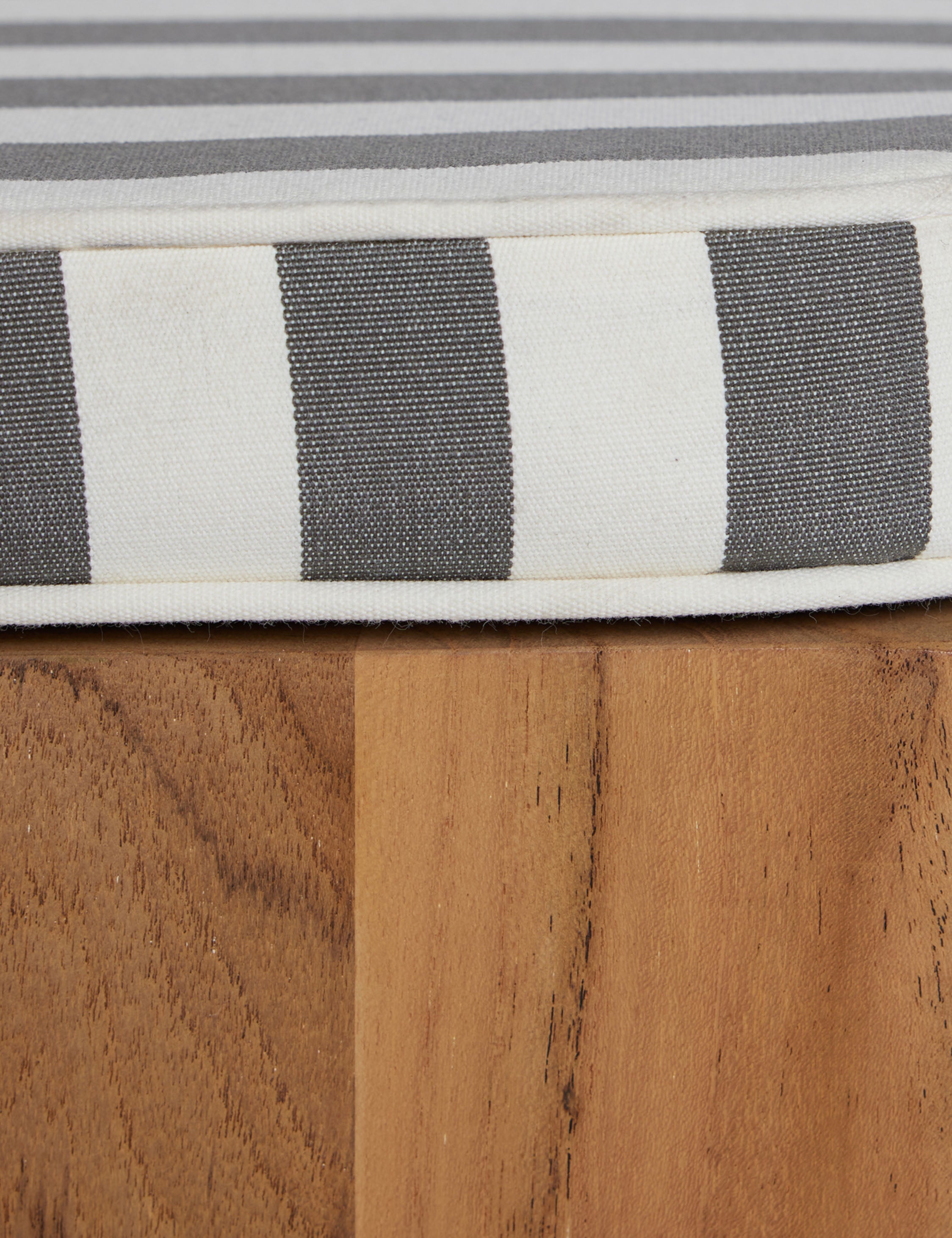 Close up of the Abbot solid teak sculptural outdoor dining chair by Sarah Sherman Samuel.