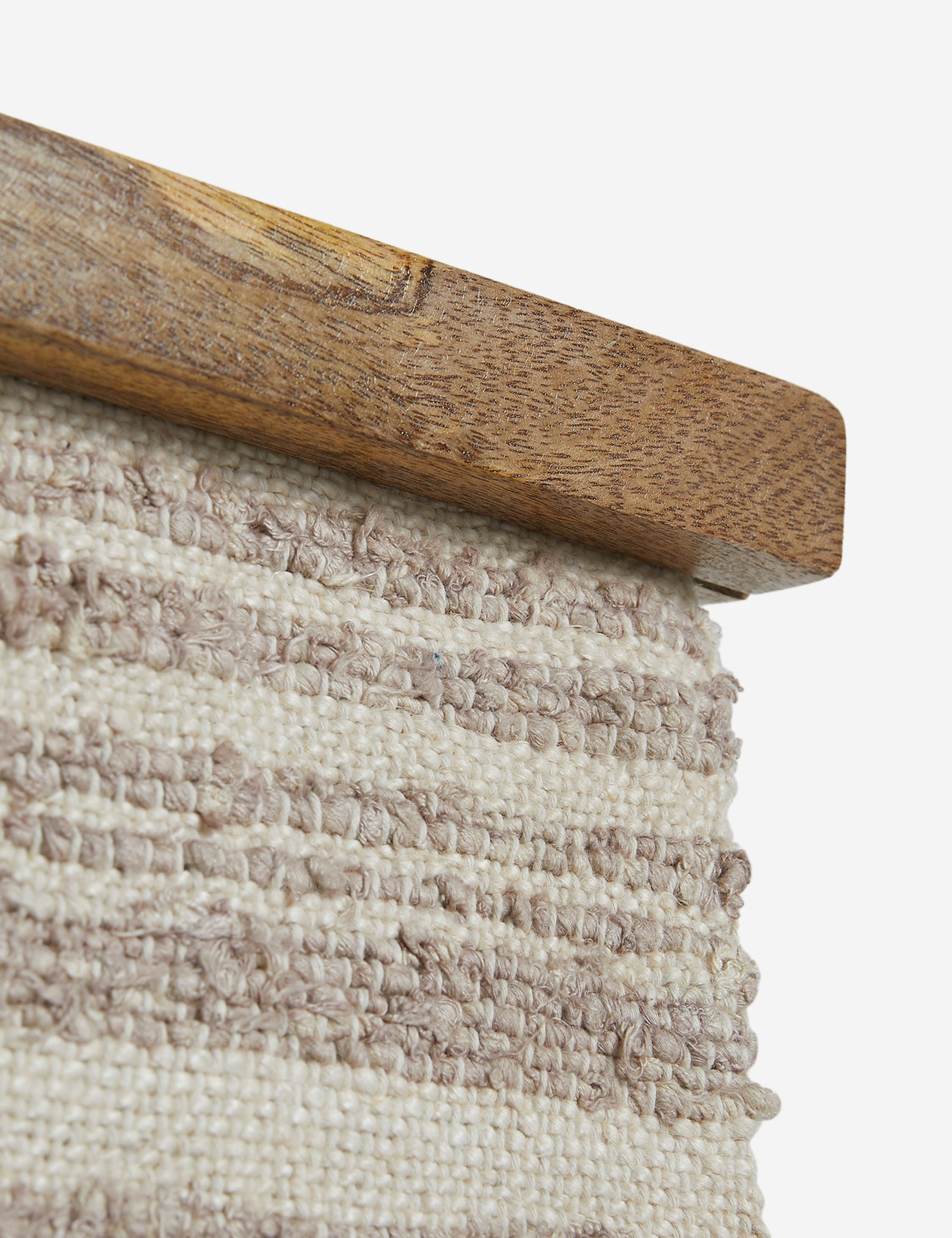Close up of the frame of the Alvah handwoven textural striped textile wall hanging.