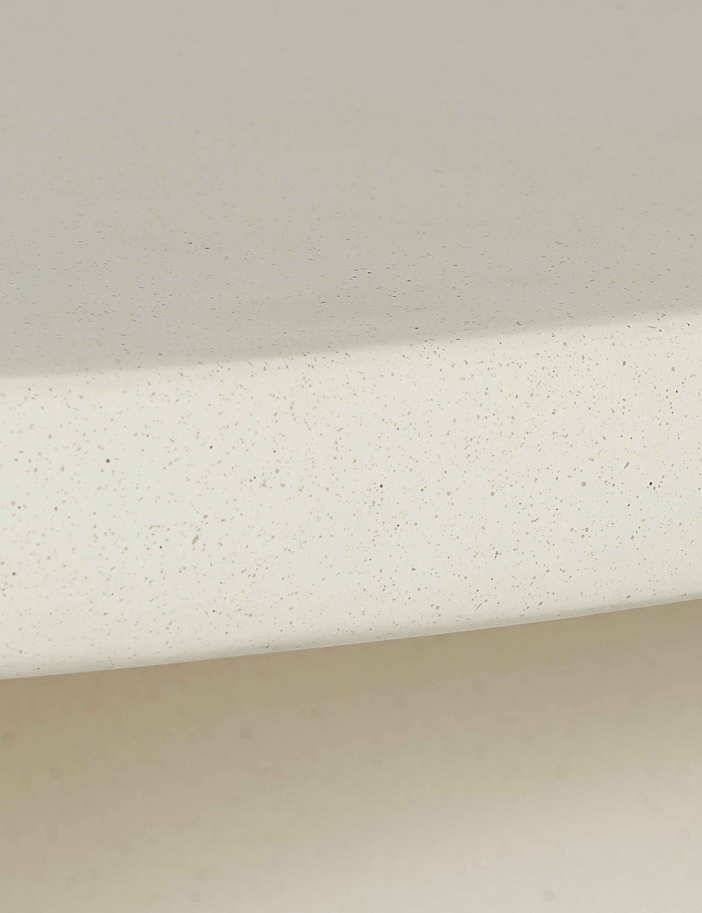 Close up of the finish of the Amaya round sculptural cement coffee table.