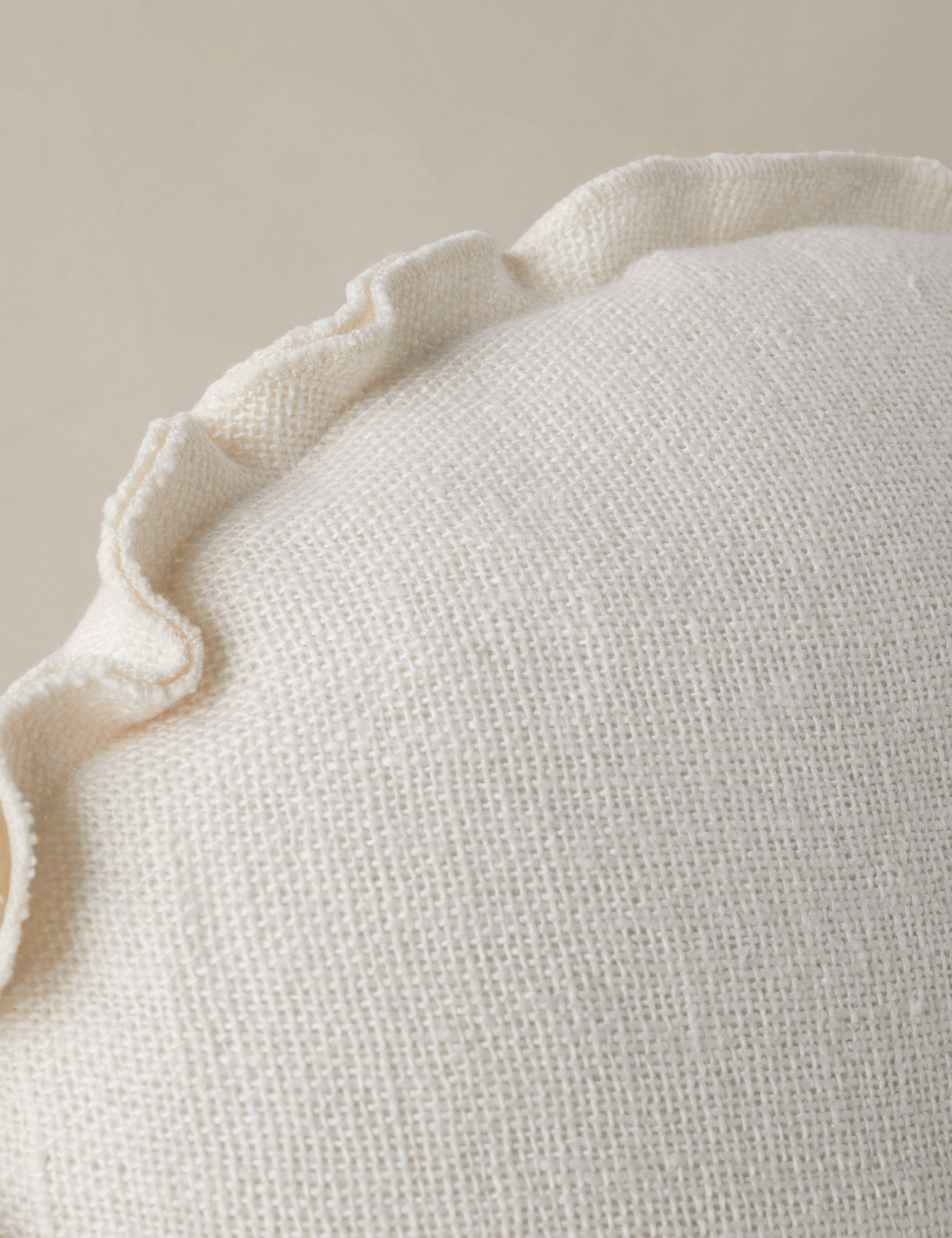 Close up of the Arlo linen flange trim round pillow.