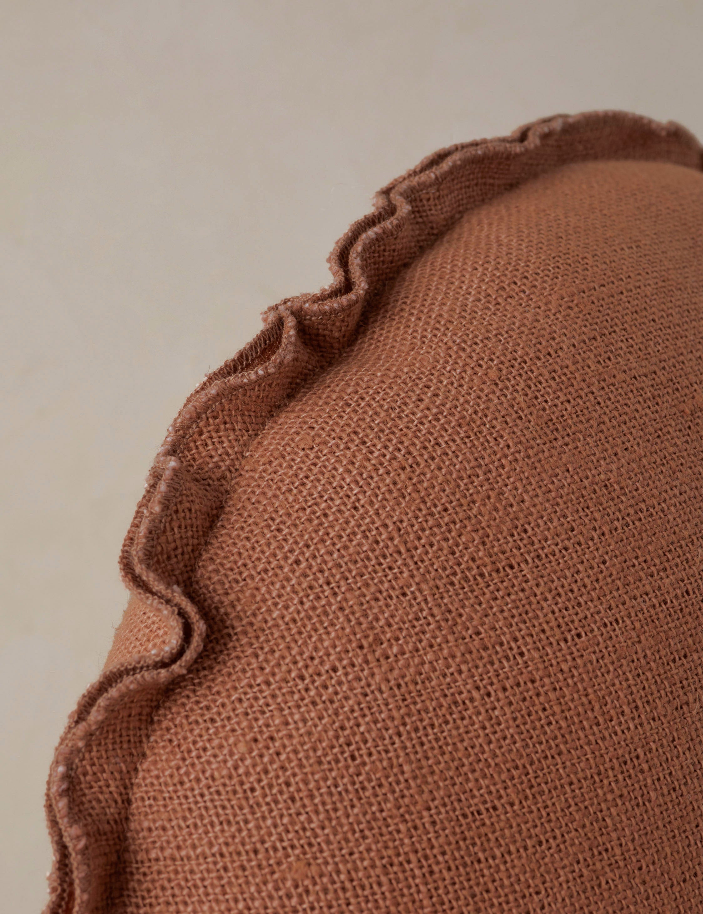 Close up of the Arlo linen flange trim round pillow.