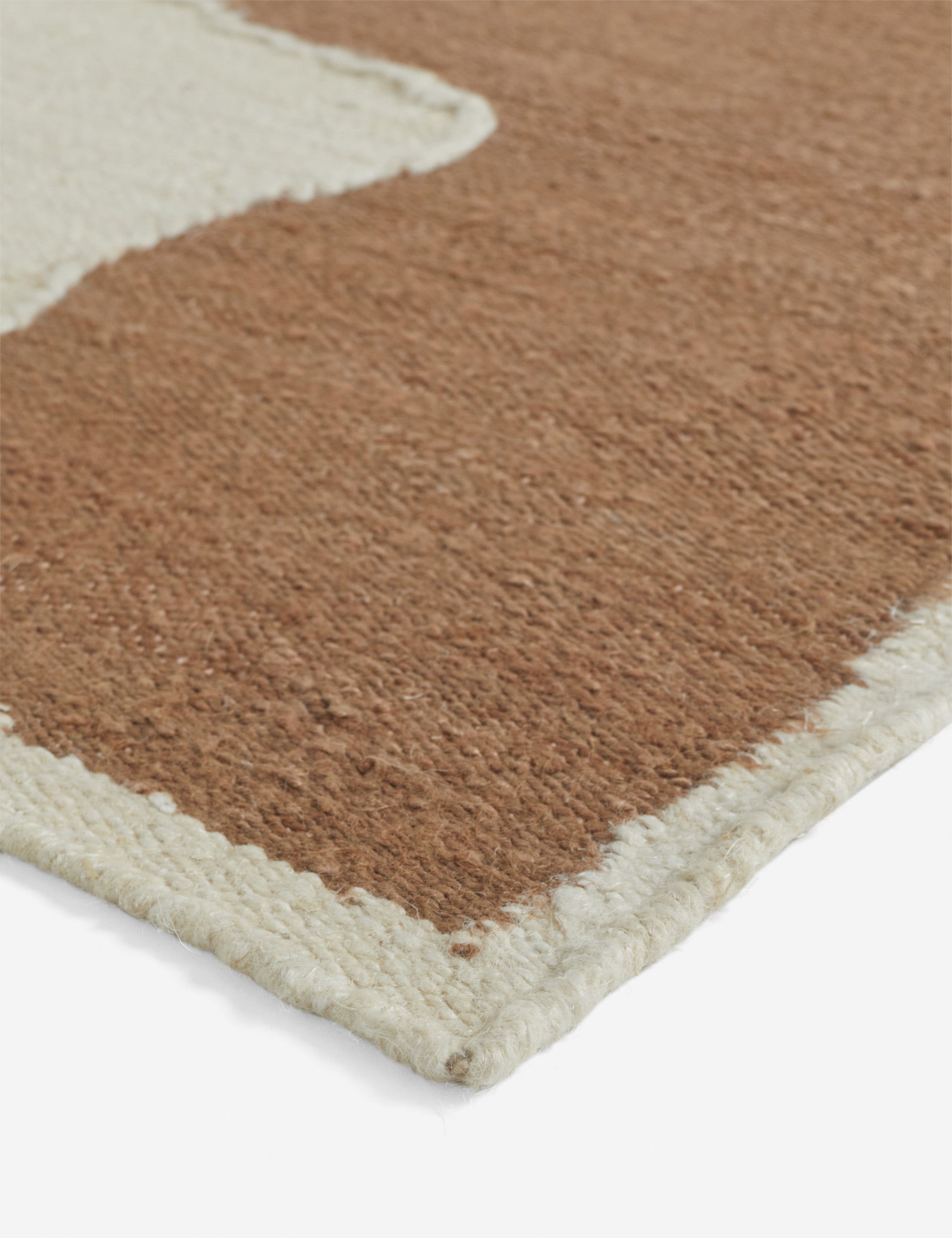 Close up view of the corner of the Butte Flatweave Linen Rug by Elan Byrd.