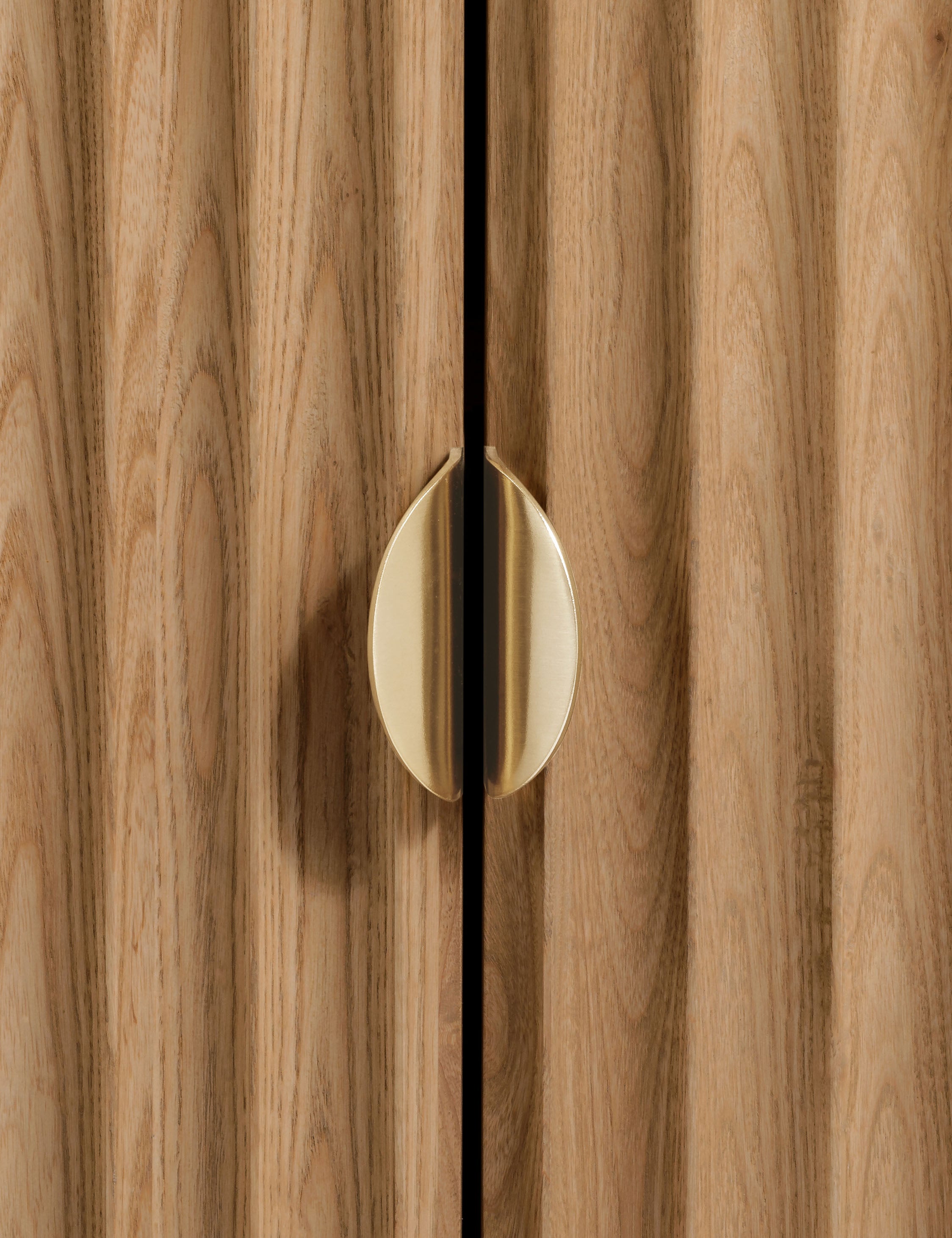 Close up of the door handle of the Matija marble top, reeded door front cabinet