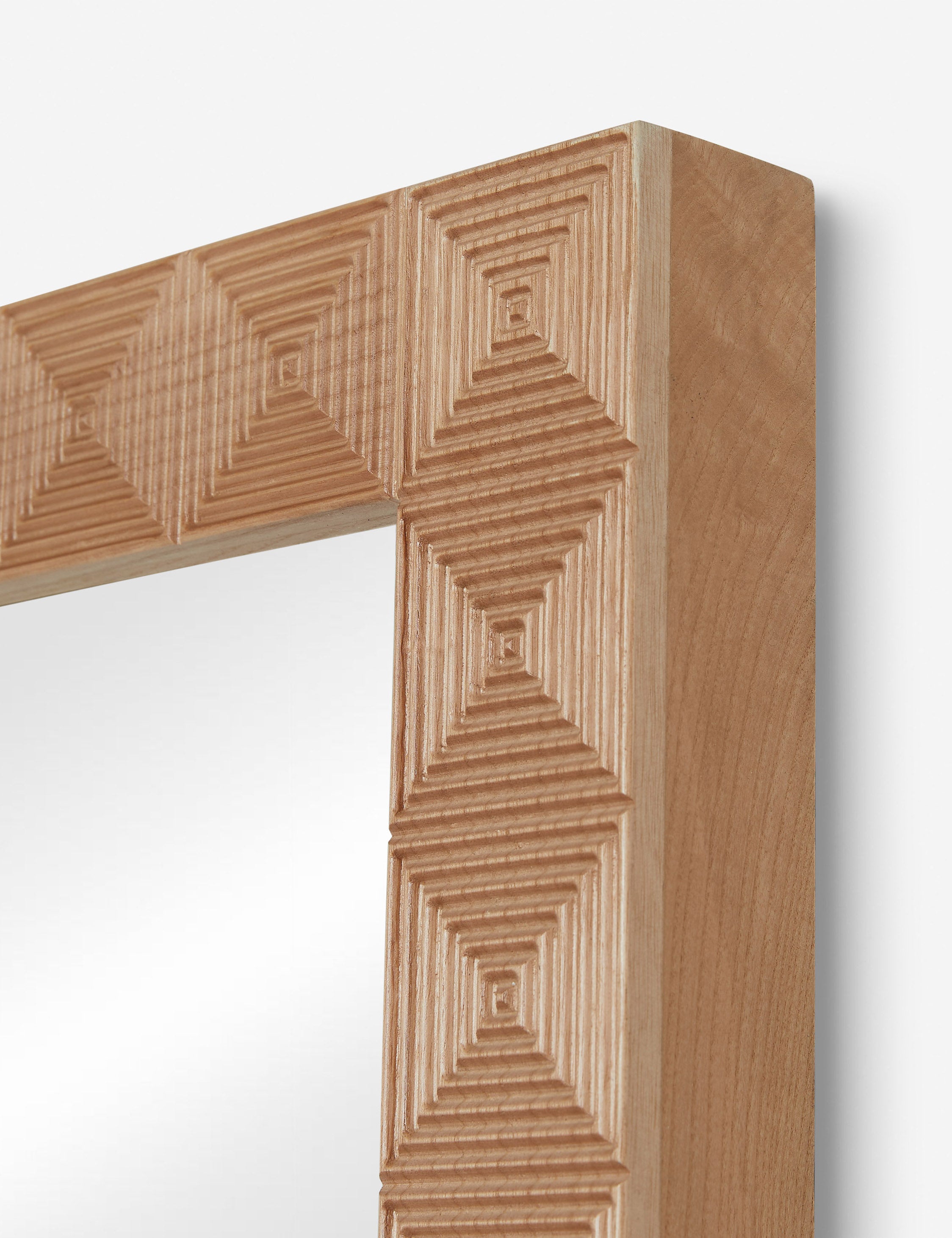 Corner of the Chelan handcrafted carved wood frame full length mirror.