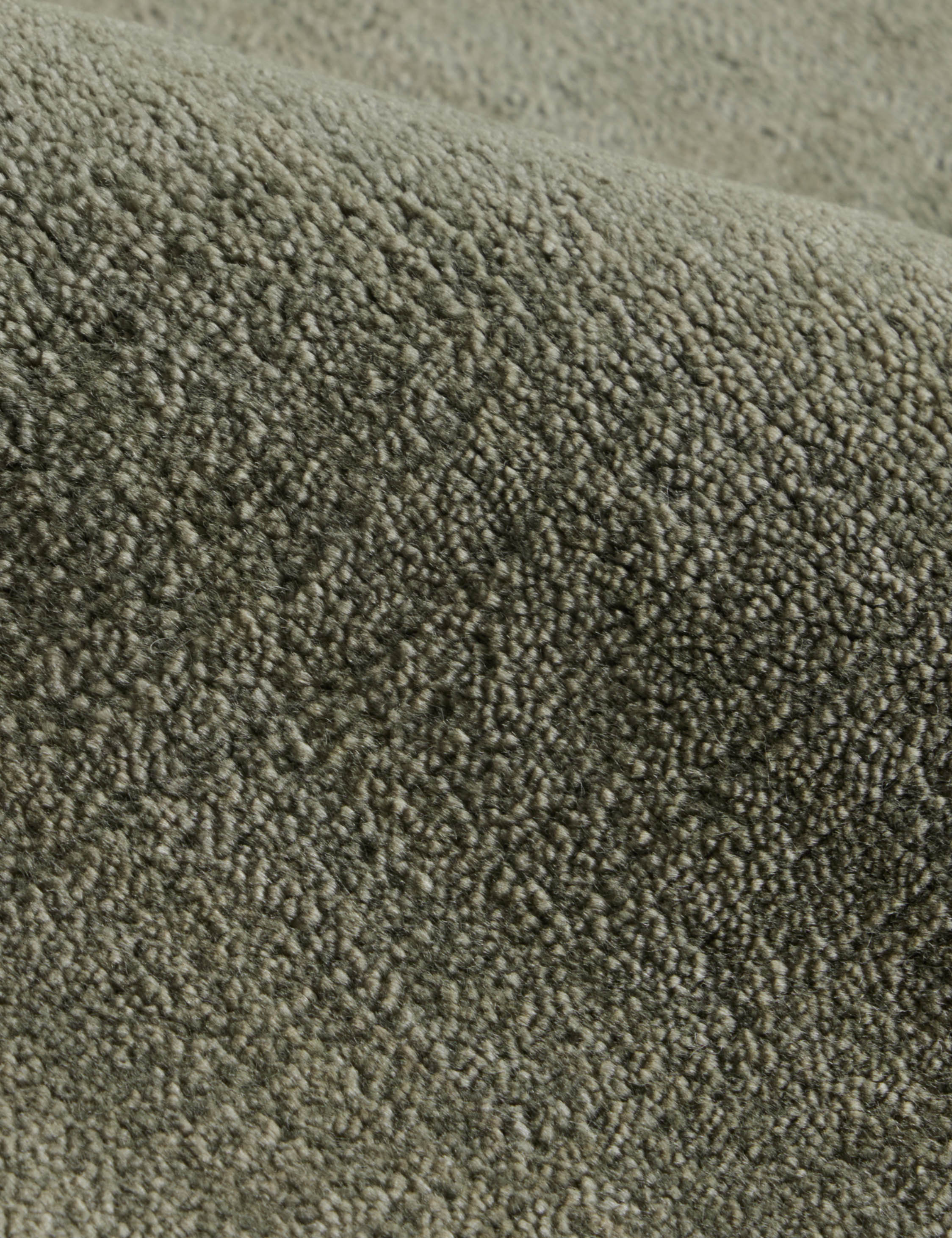 Close up of the Damara solid viscose rug in sage.