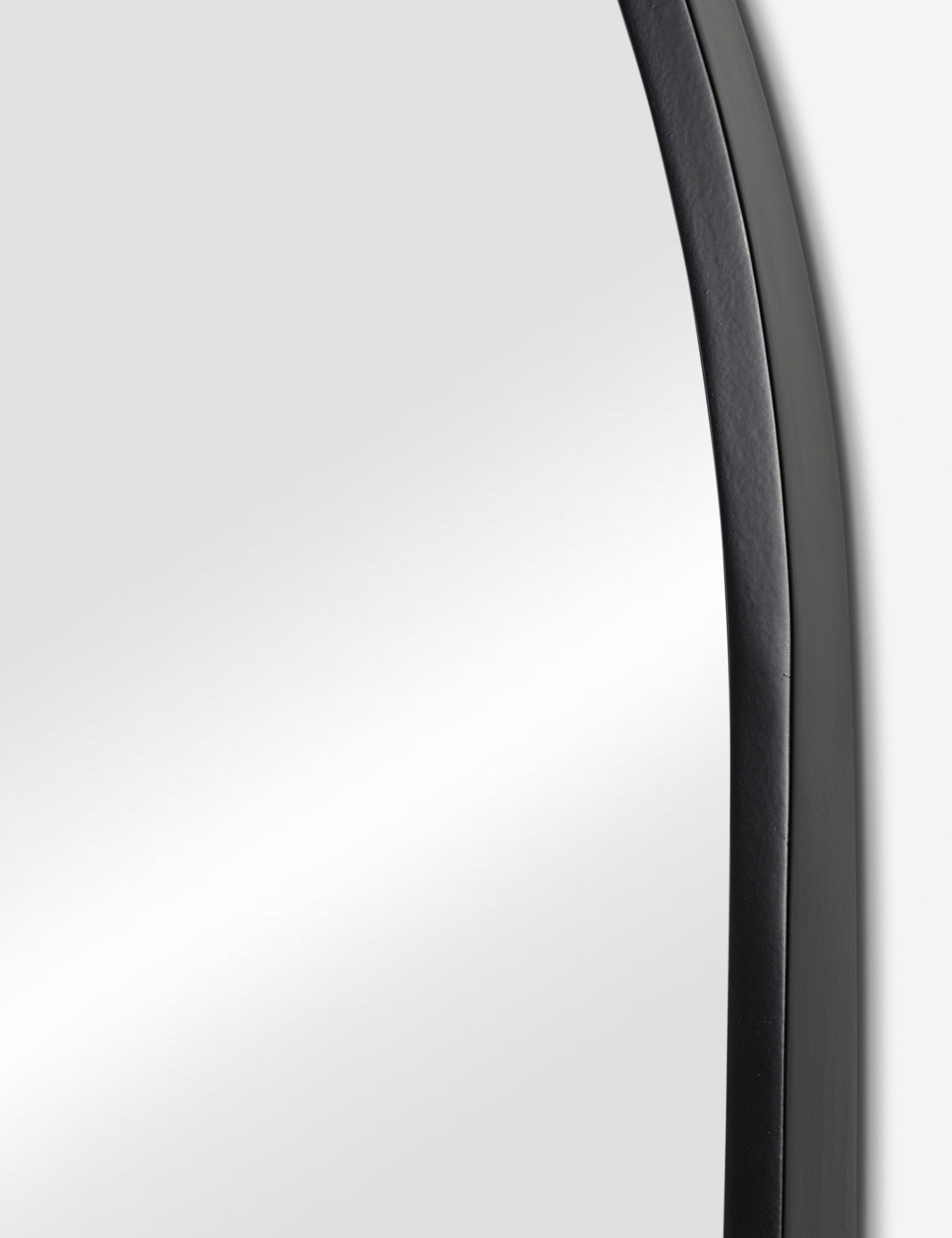 Close up of Idris thin metal framed floor length mirror in black