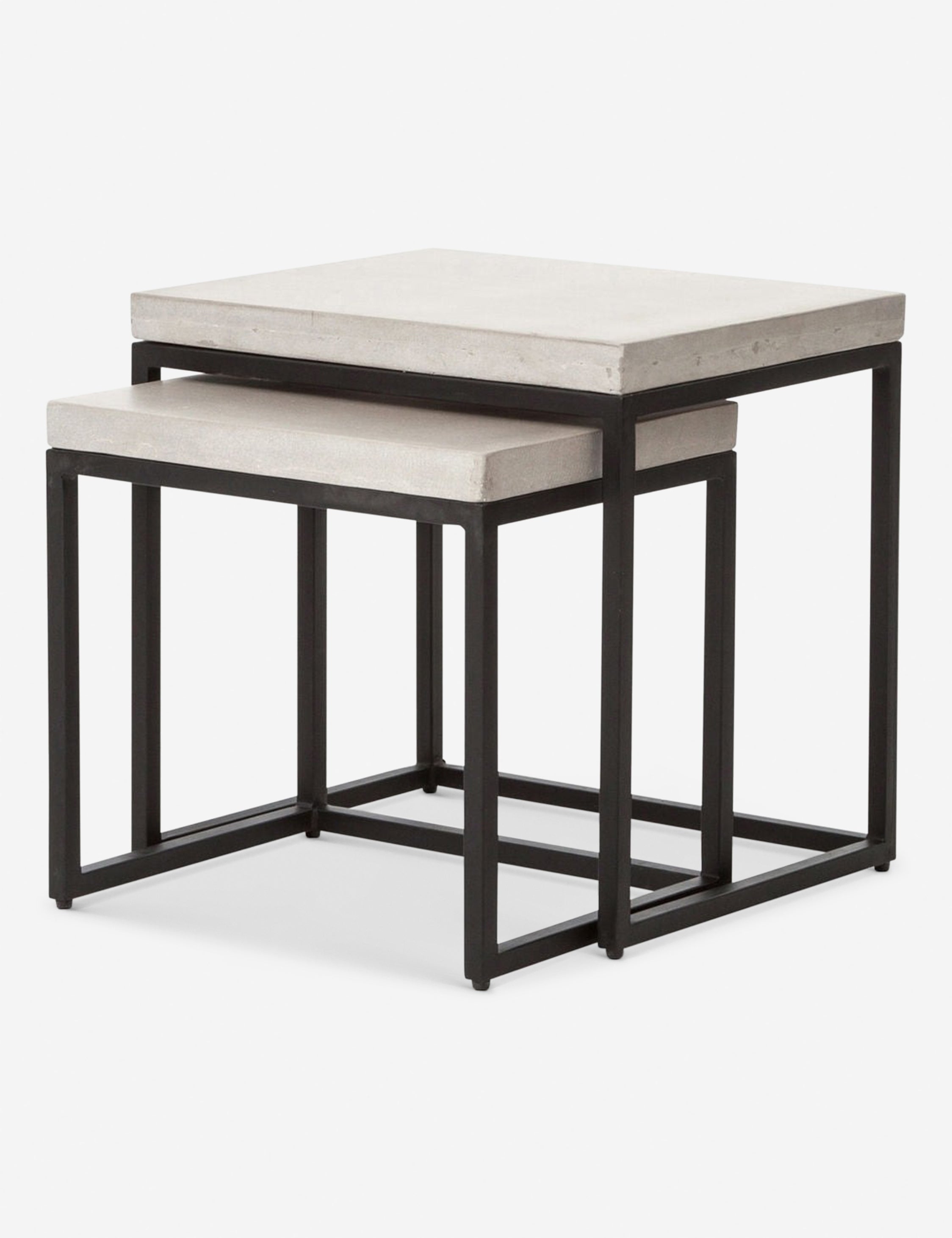 Angled view of the Kallia indoor and outdoor nesting side tables with iron bases and concrete tops with the smaller table half nested into the bigger table