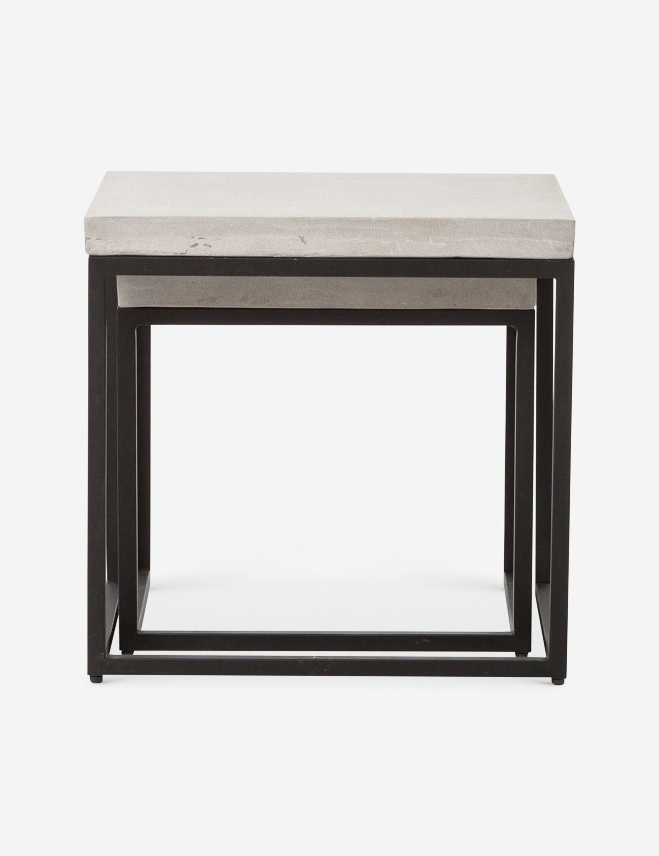 The Kallia indoor and outdoor nesting side tables with iron bases and concrete tops with the smaller table fully nested into the bigger table