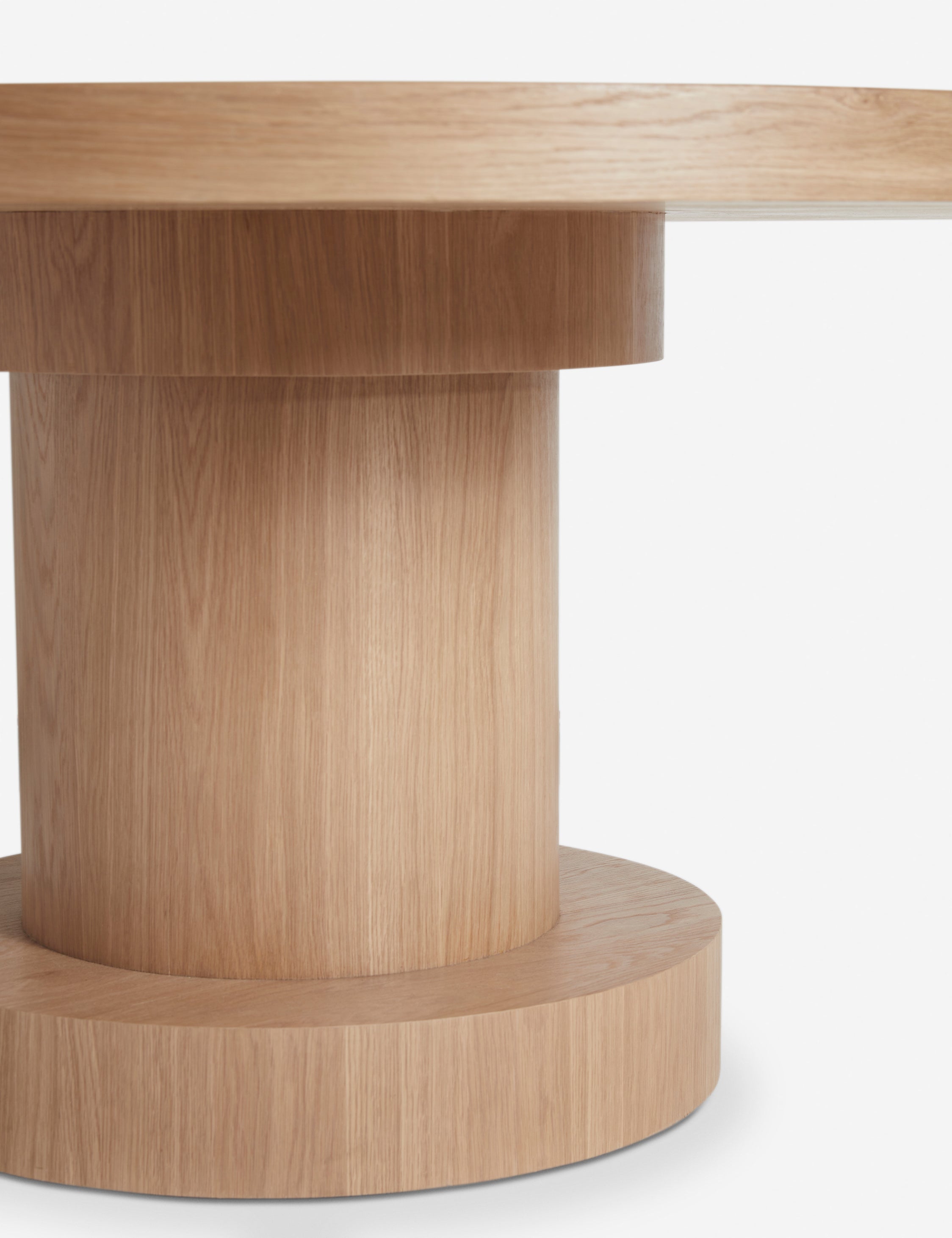 Close up view of the Karine round natural wood pedestal dining table base