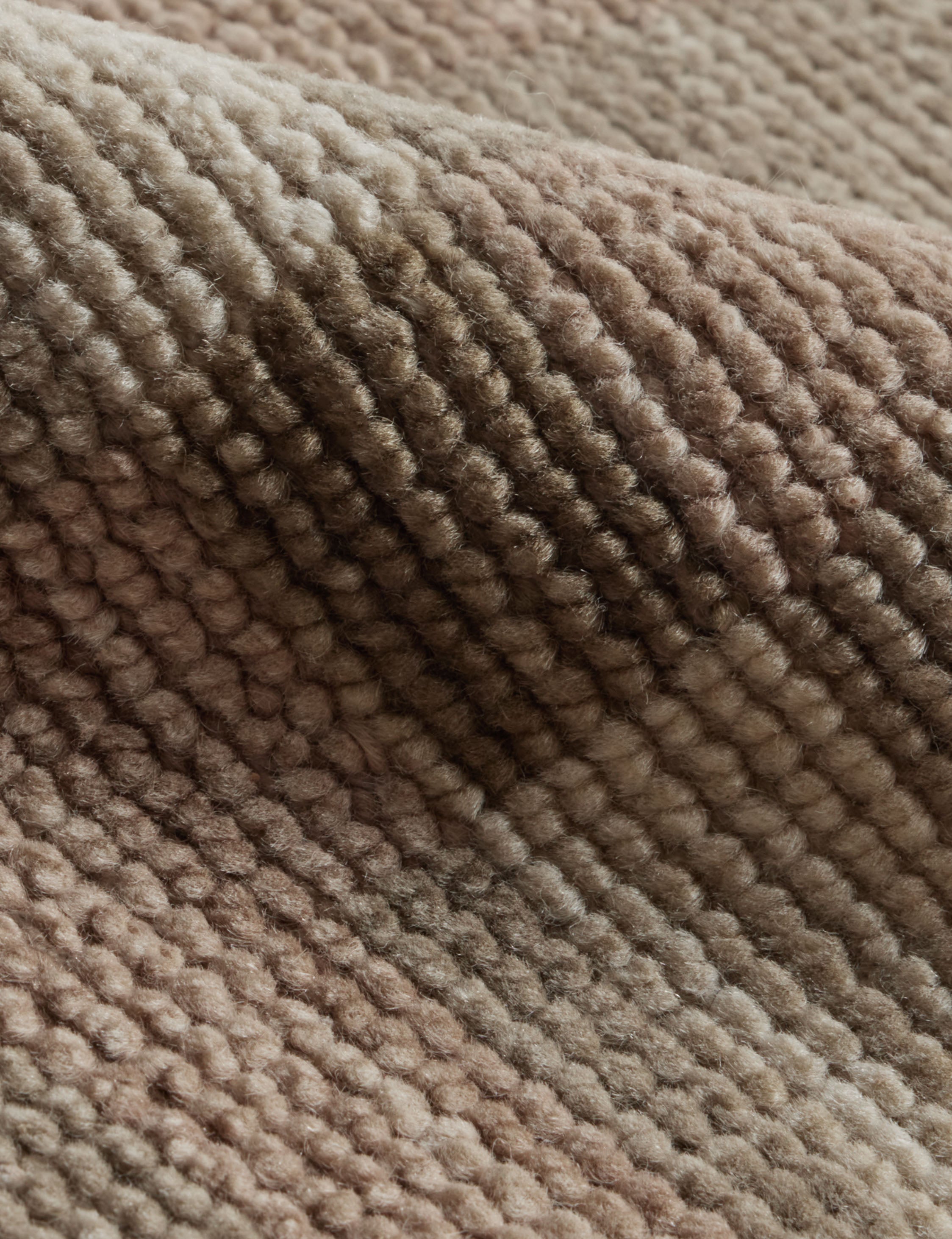 Close up of the Lalan hand-knotted geometric pattern wool rug.