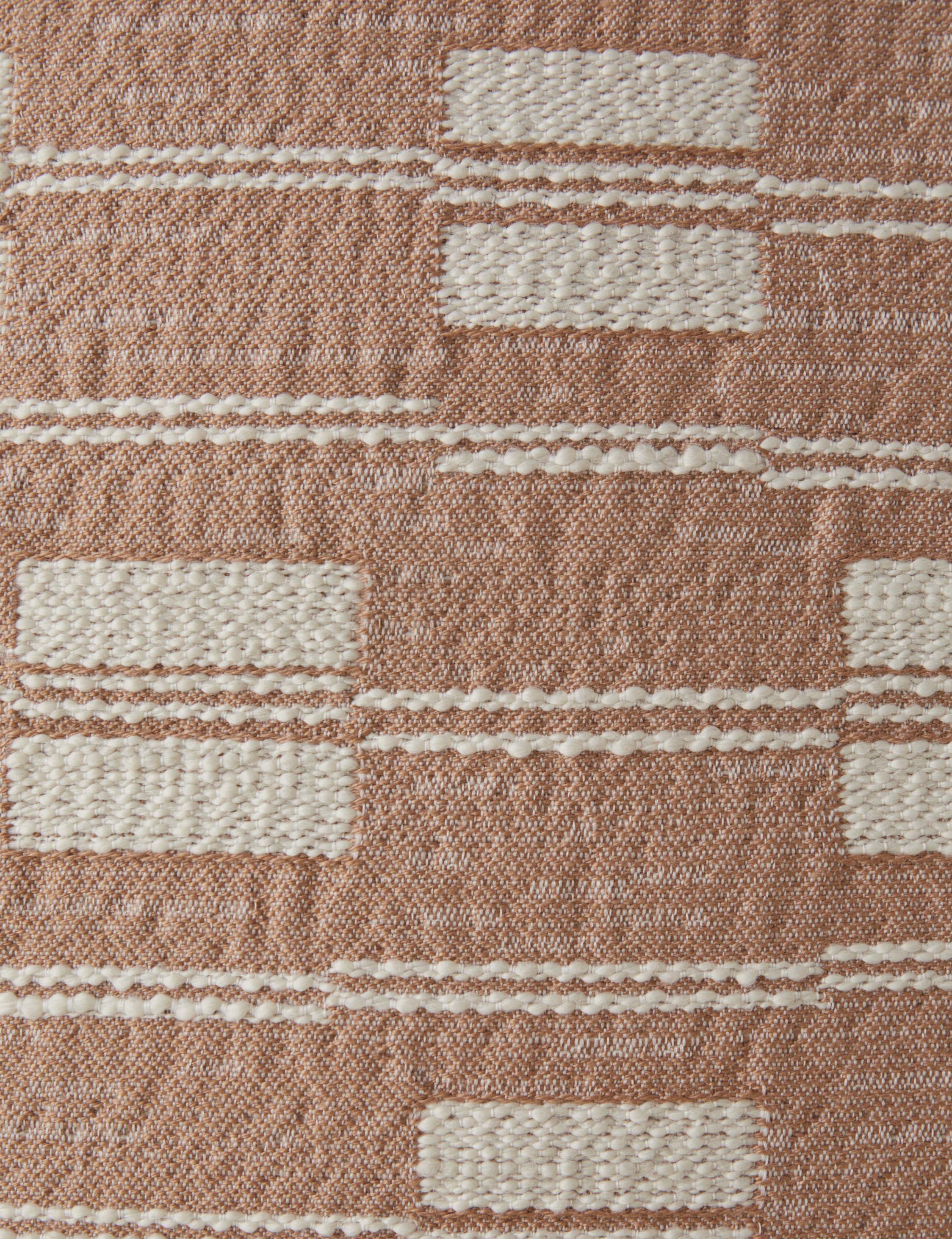 Close up of the Leighton broken stripe pillow in terracotta.