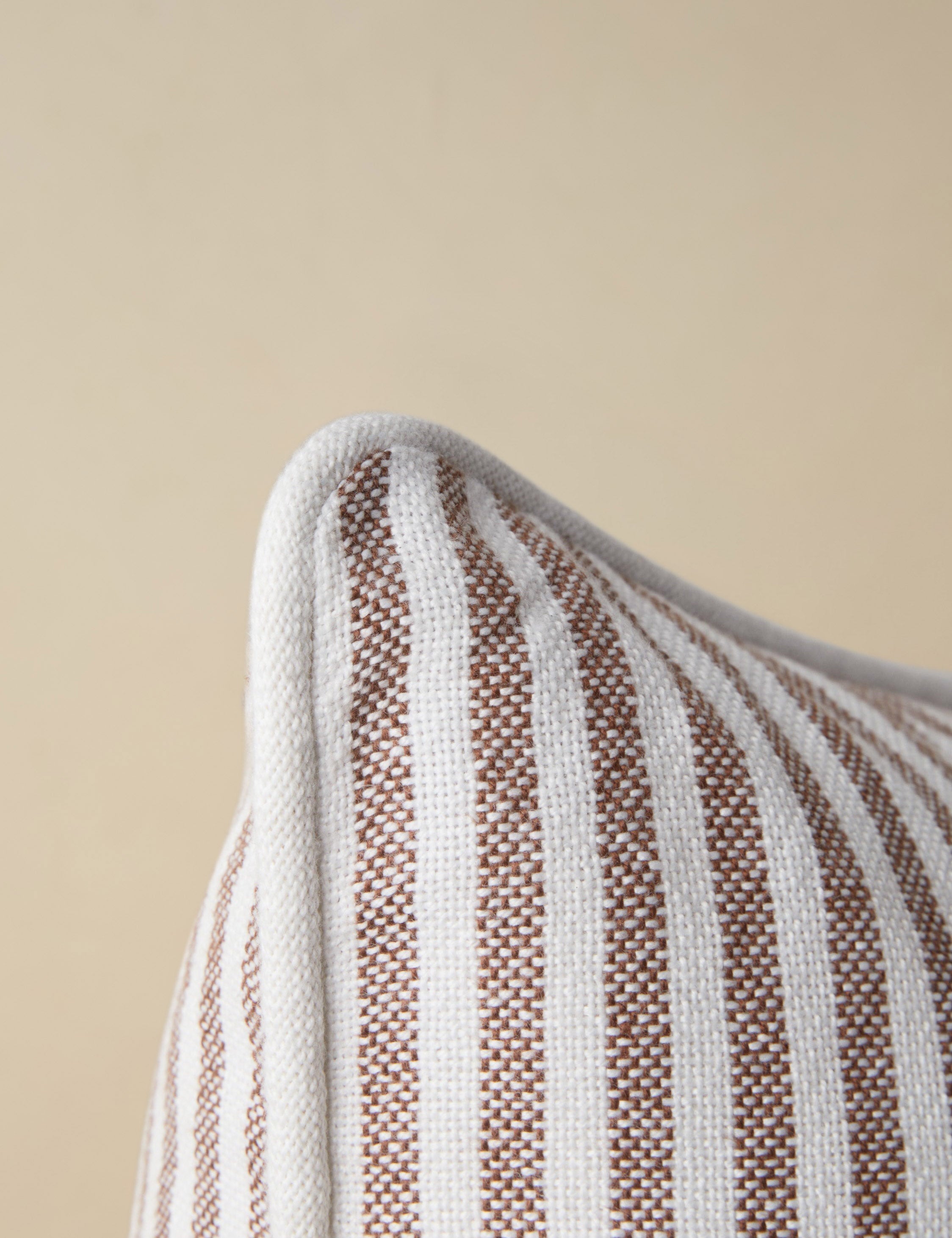 Close up of the corner of the Littu Indoor / Outdoor Striped Throw Pillow by Sarah Sherman