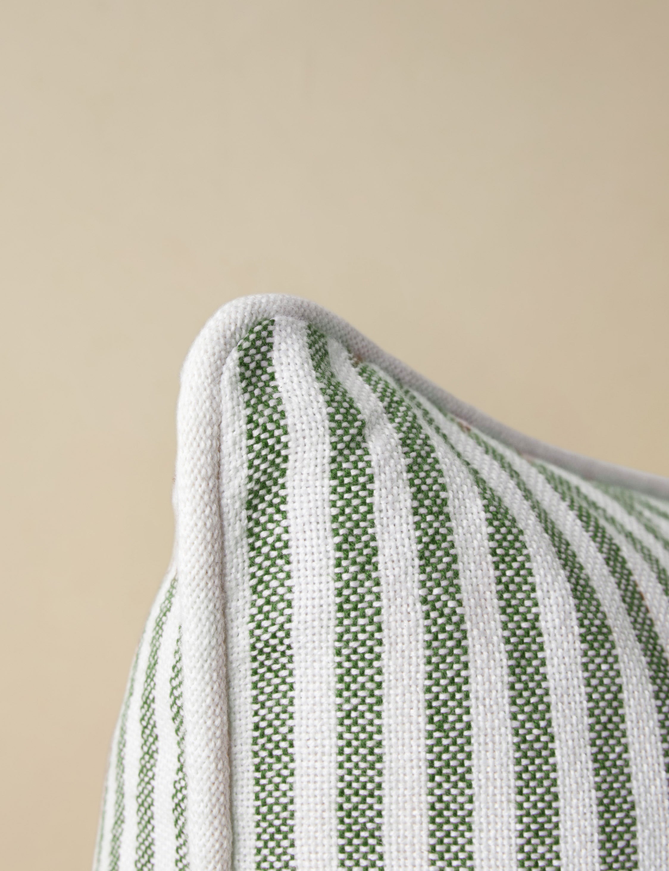 Close up of the corner of the Littu Indoor / Outdoor Striped Throw Pillow by Sarah Sherman