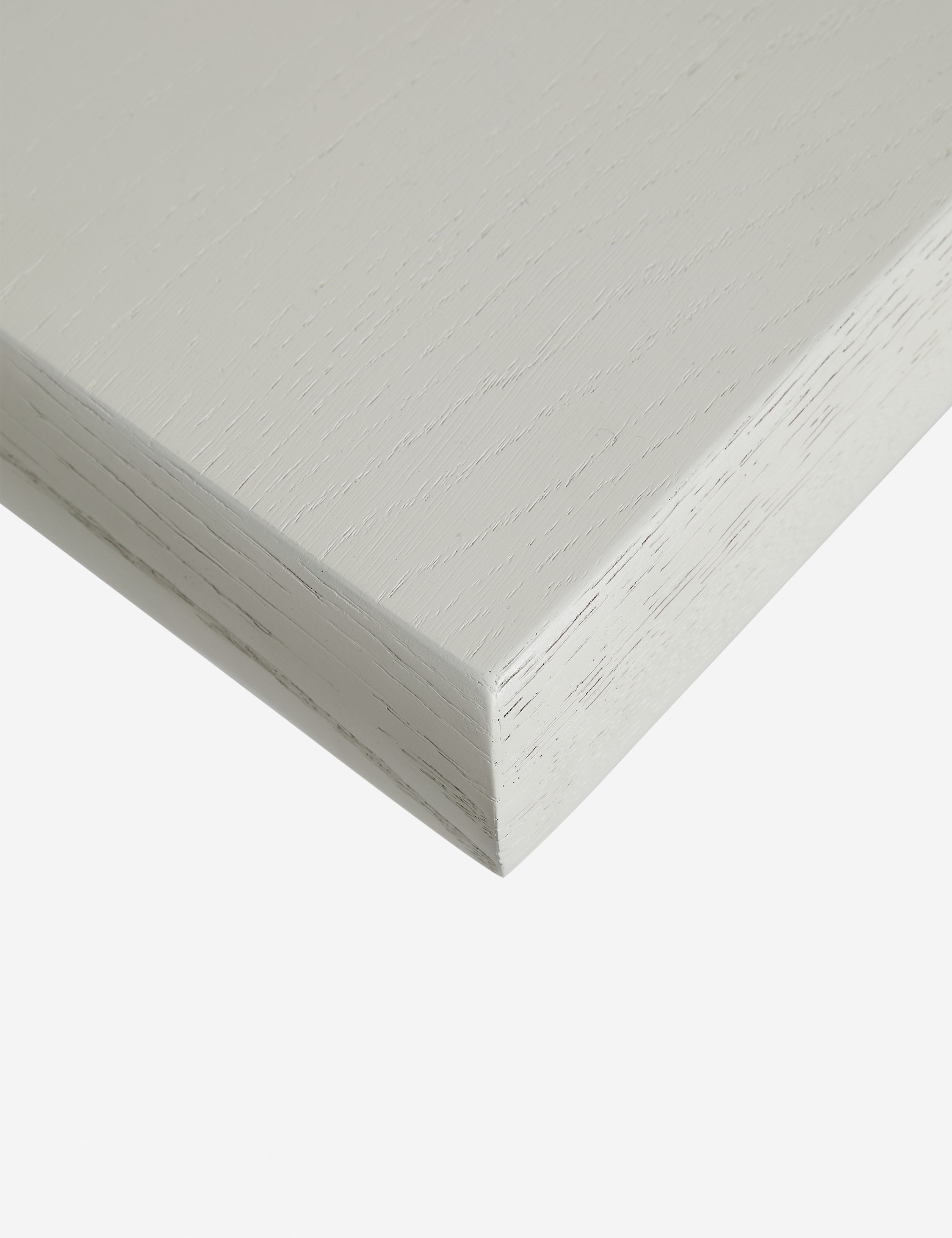 Close up of the corner of the Lowen double pedestal base white washed dining table.