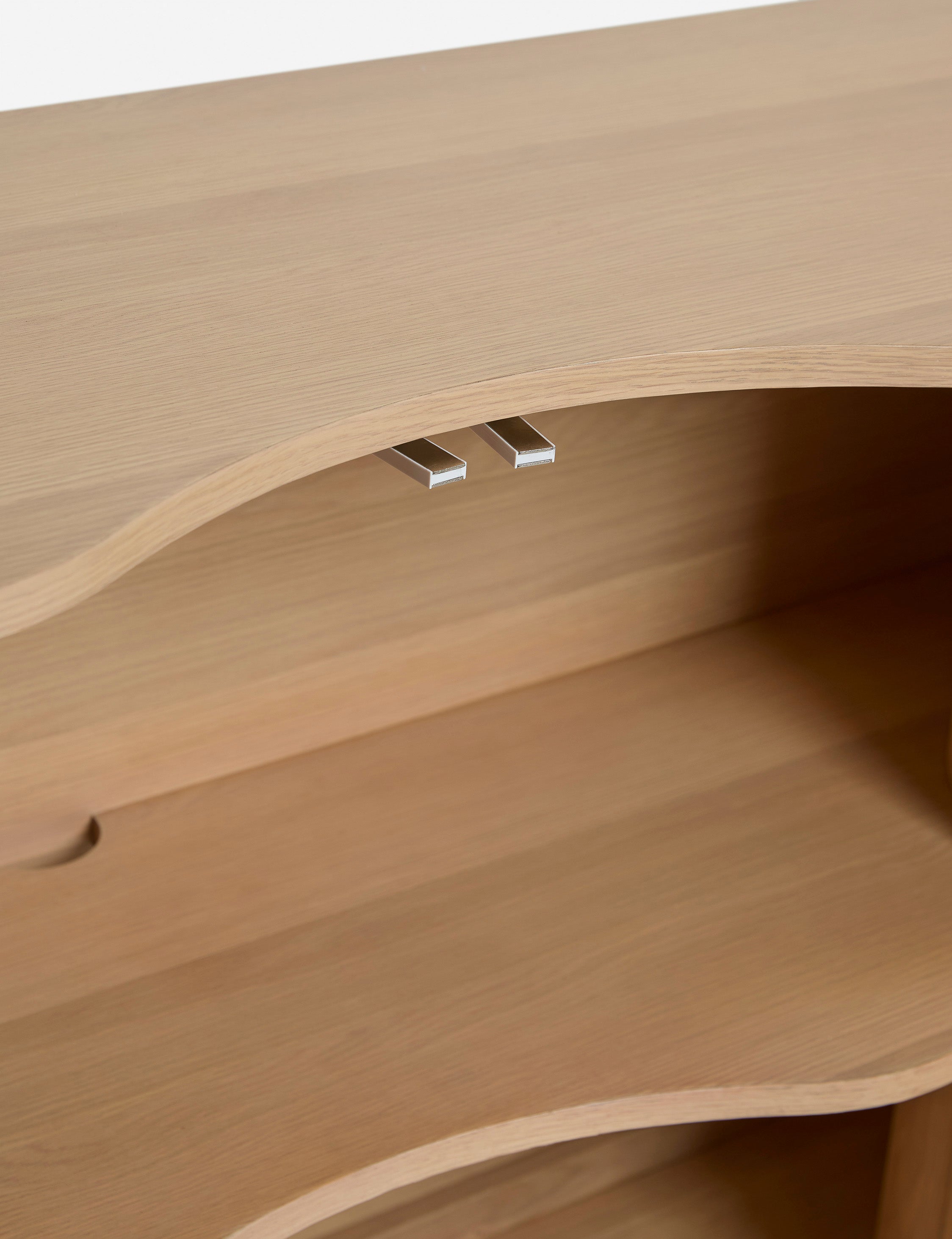 Close up of the Cora half-moon, wavy light-wood sideboard