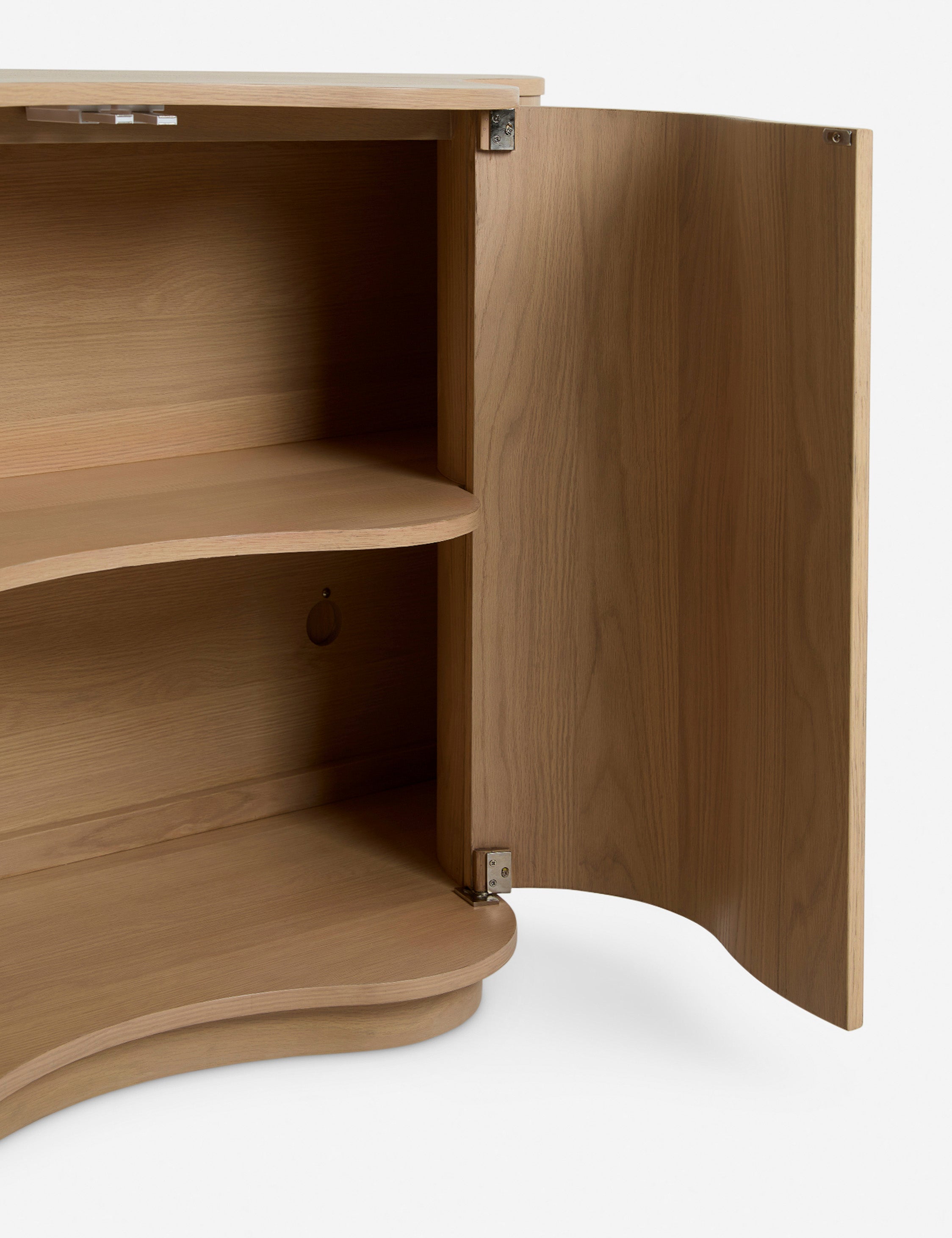 Close up of the Cora half-moon, wavy light-wood sideboard with open door