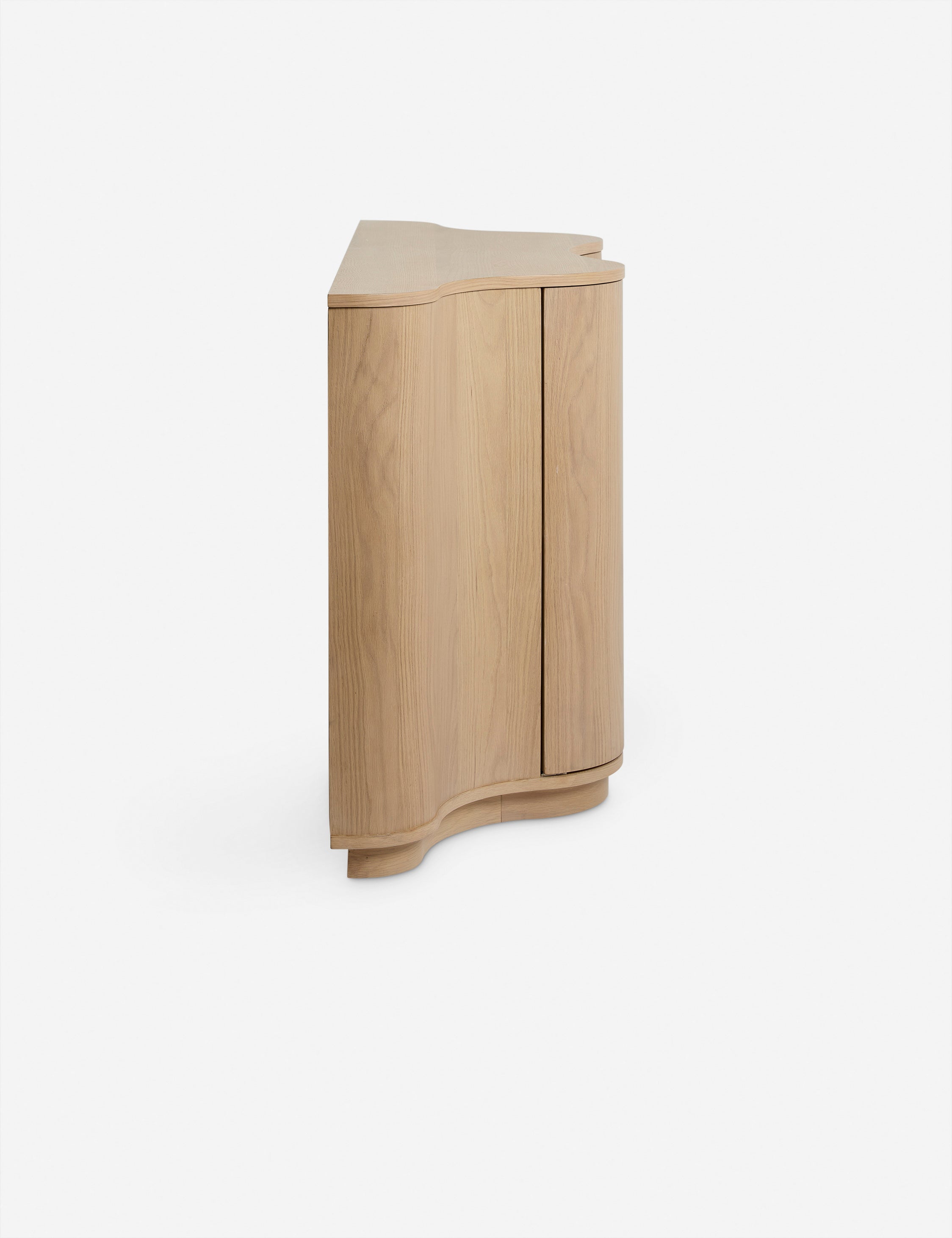 Side view of the Cora half-moon, wavy light-wood sideboard