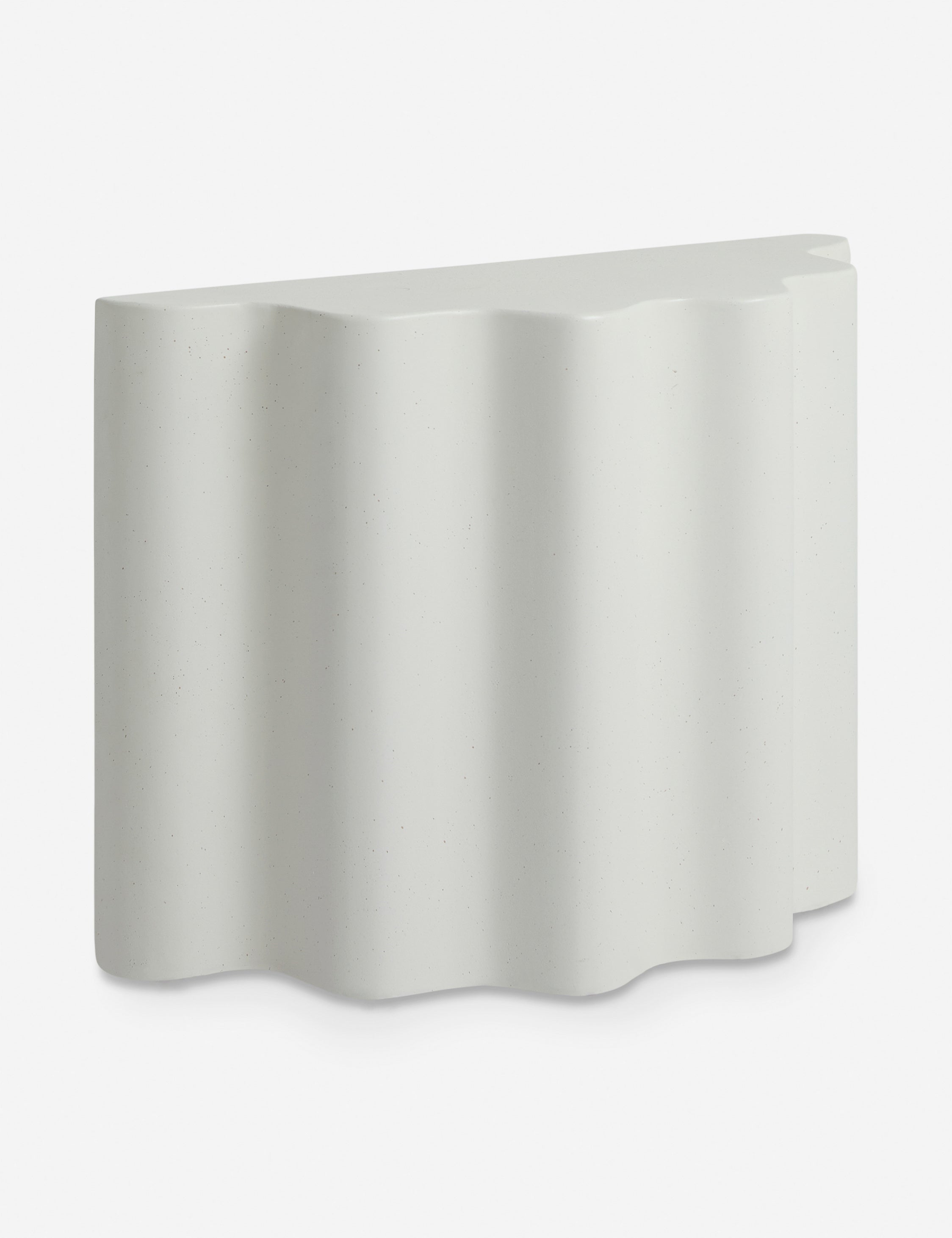 Angled view of the Lune half-moon, scalloped concrete side table