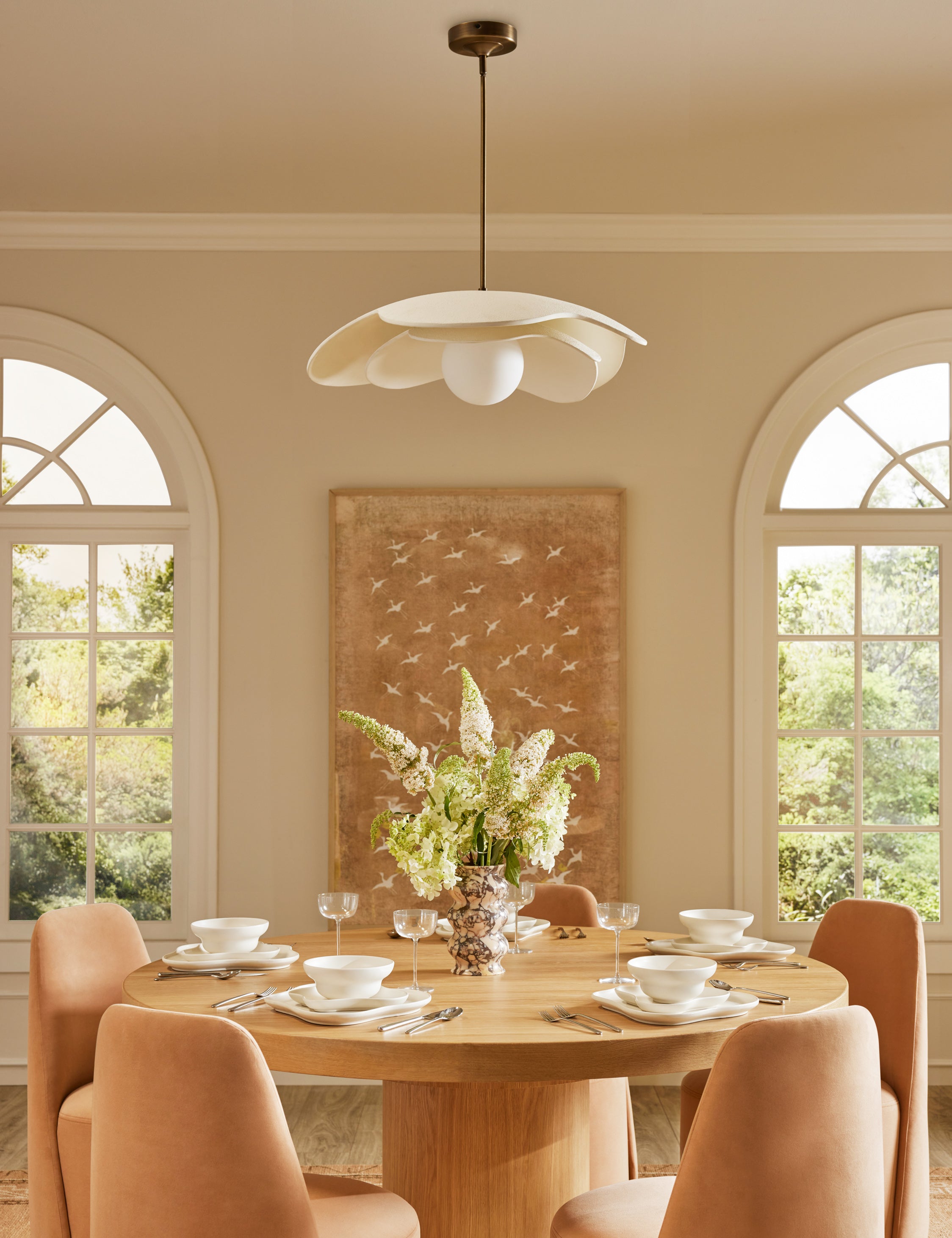 Soft Petal matte white floral silhouette pendant light hanging over a dining table