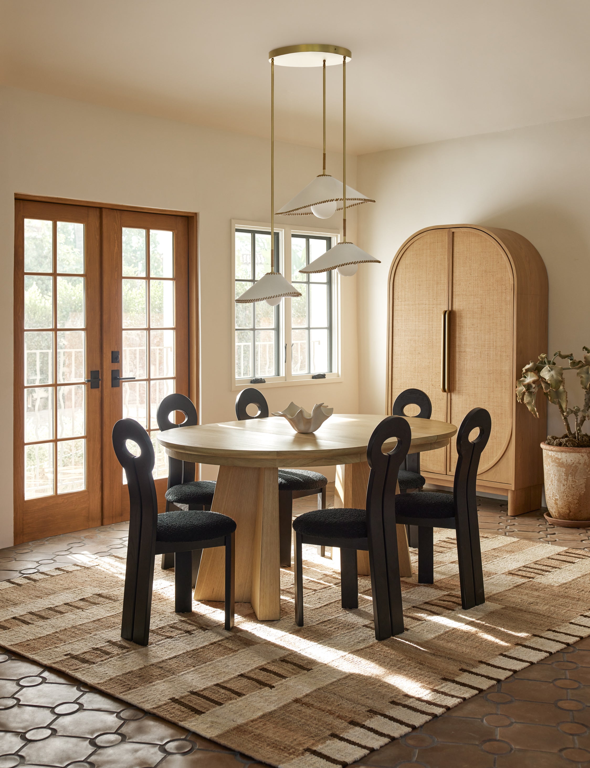 Tempo Flatweave Jute Rug by Elan Byrd styled in a dining room.