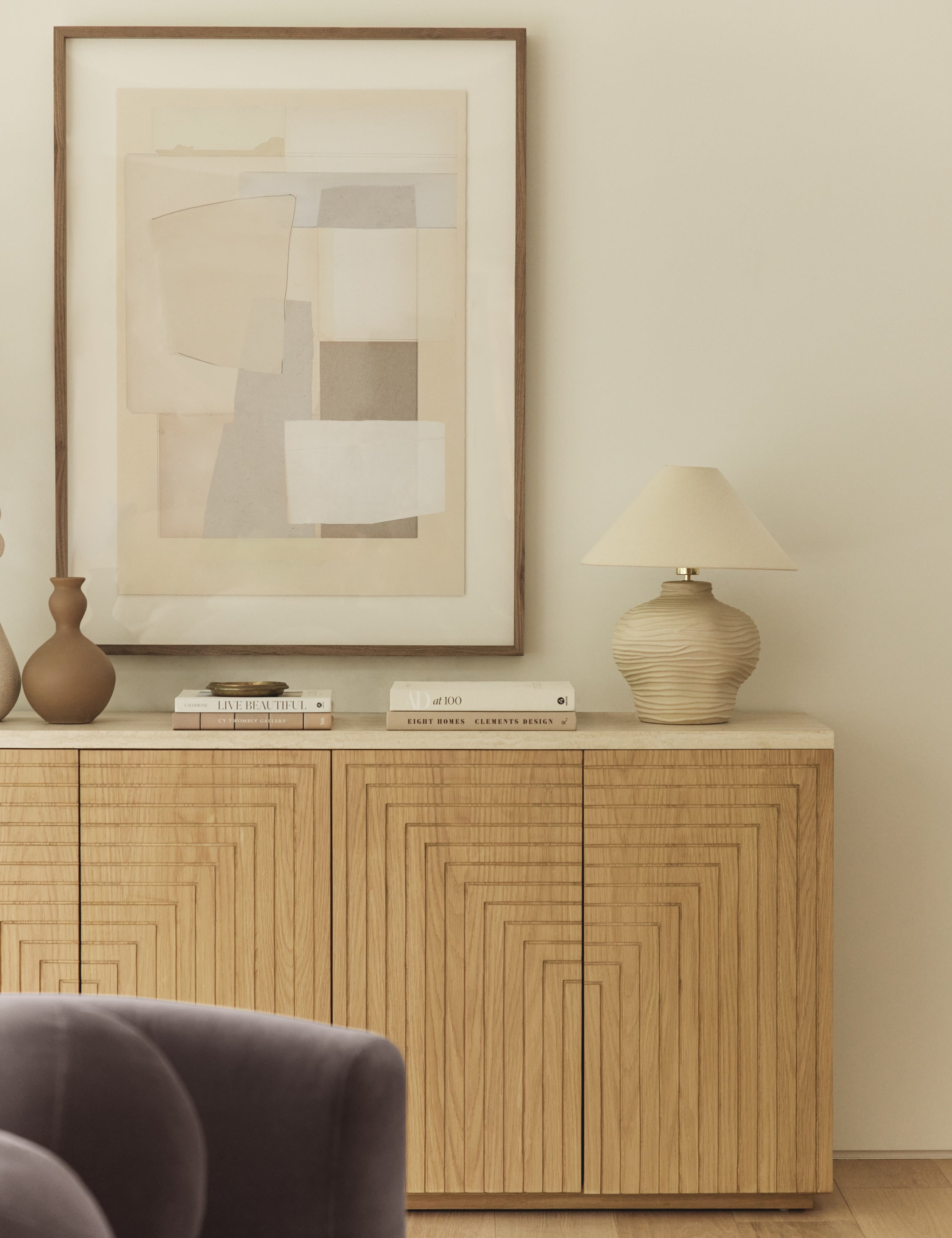Wrinkle ceramic table lamp by Sarah Sherman Samuel styled on a sideboard cabinet.