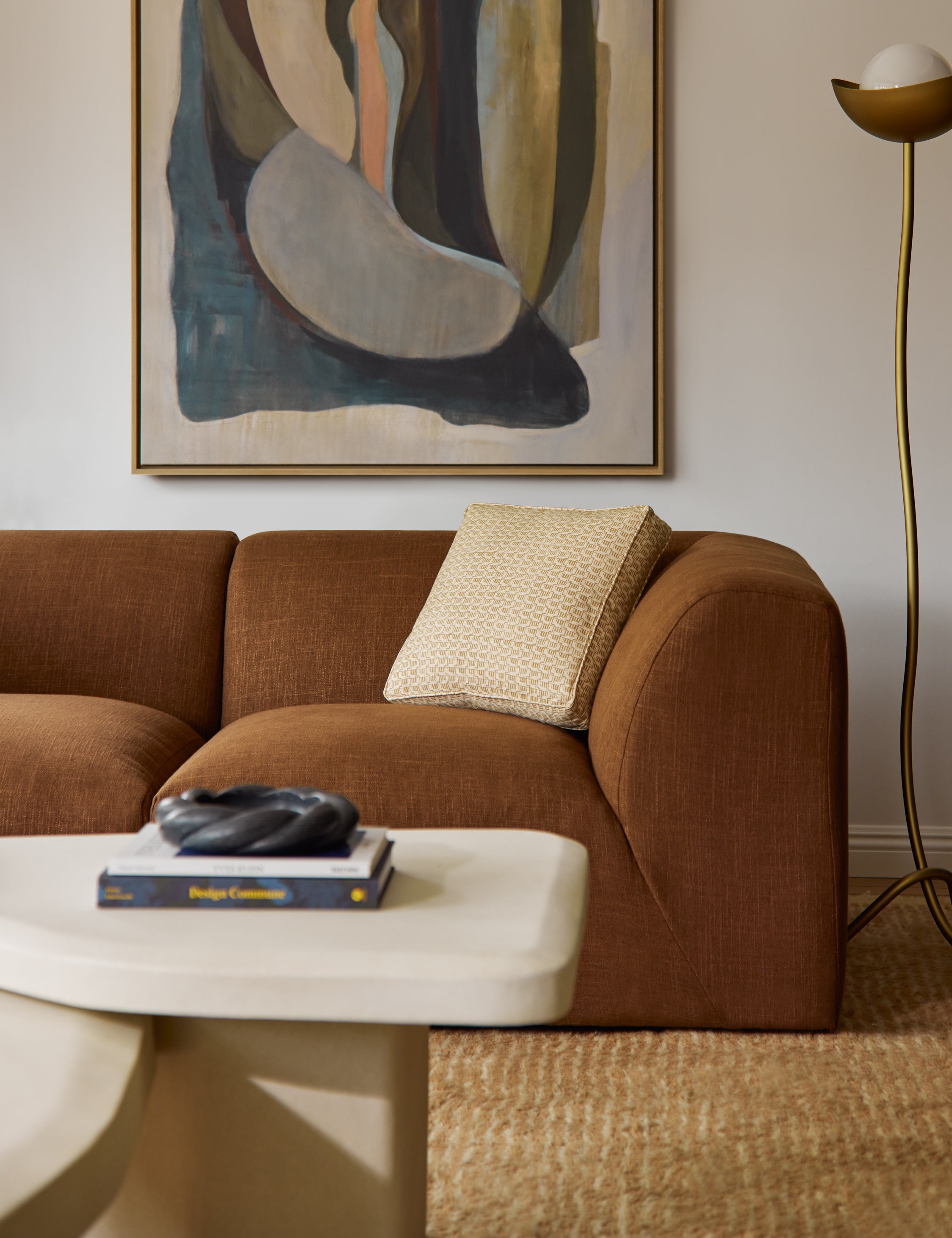 Sweeney box silhouette abstract print throw pillow styled on a sofa.