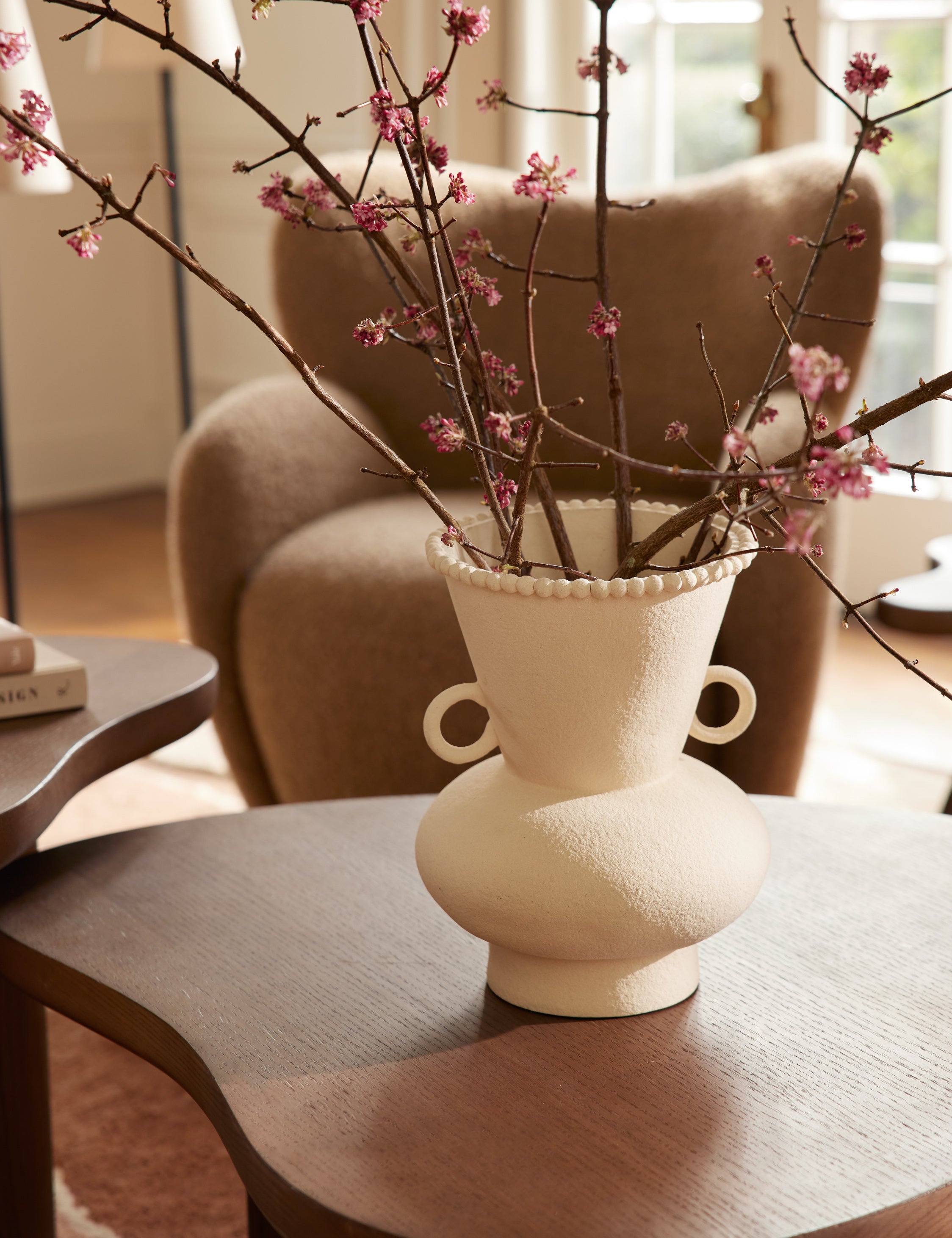 Philia wide beaded rim loop handle ceramic vase by Aimee Song styled on a coffee table