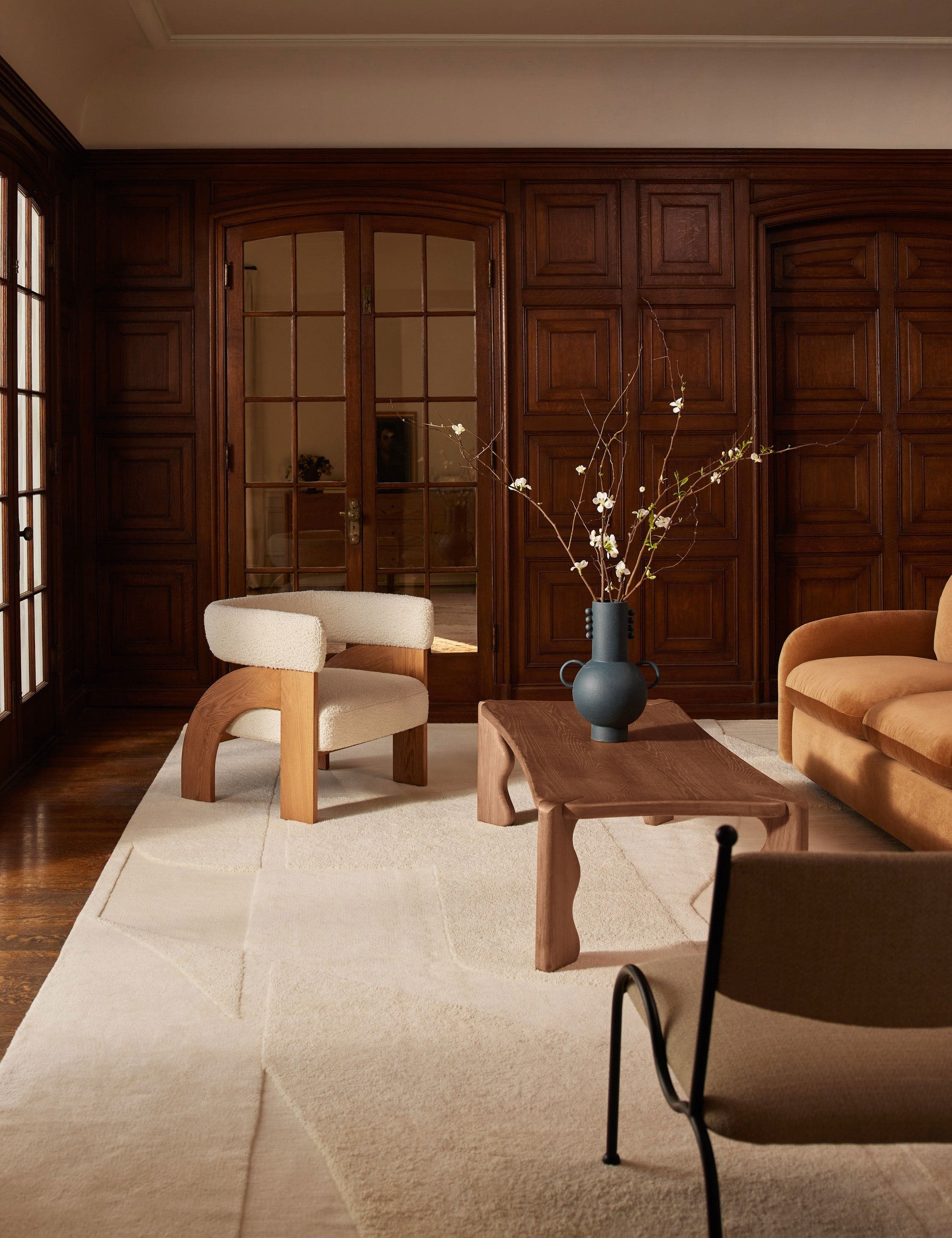 Living room featuring the Grifo wavy sculptural oak coffee table by Aimee Song