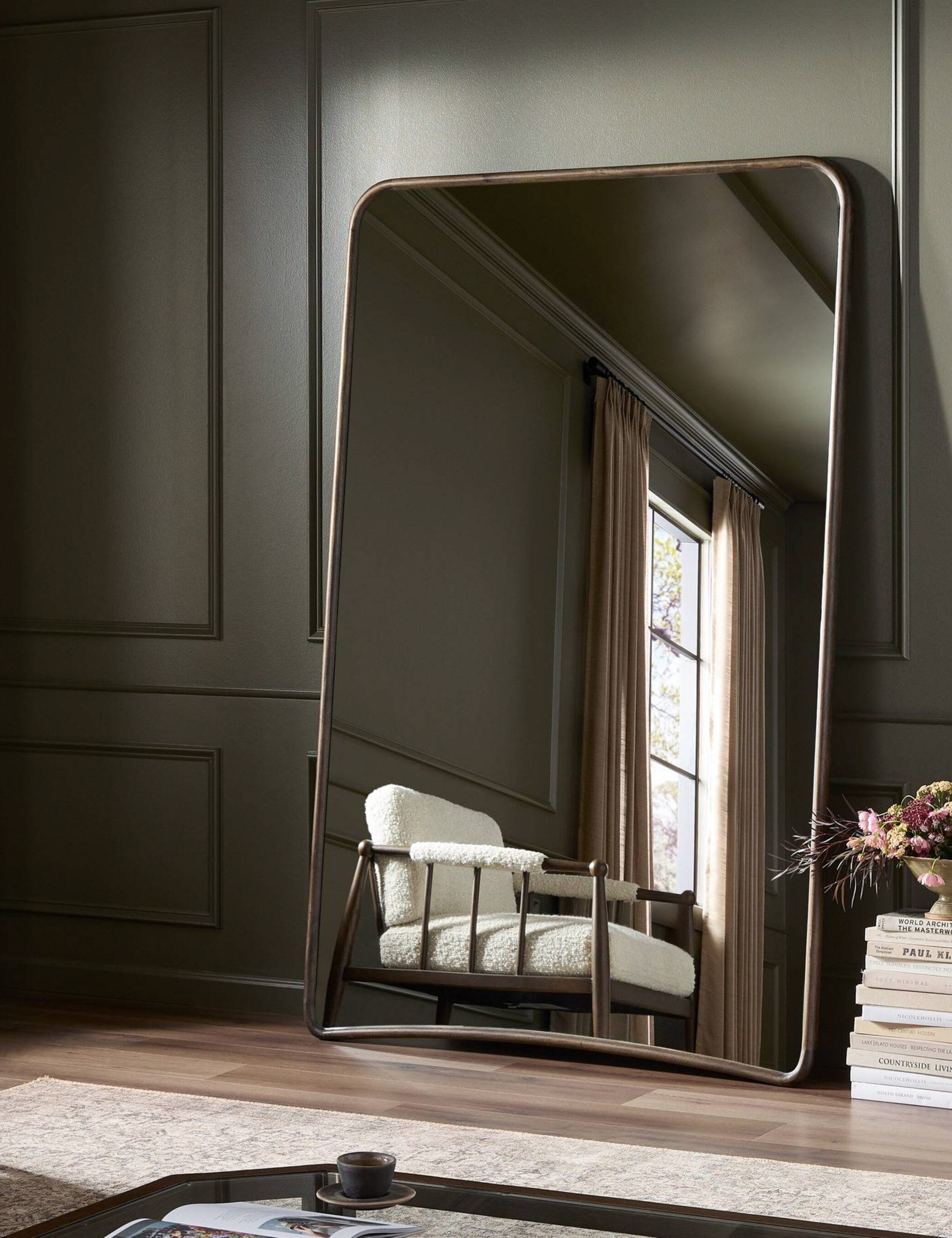 Picart arched base slim frame floor mirror leaning against a wall