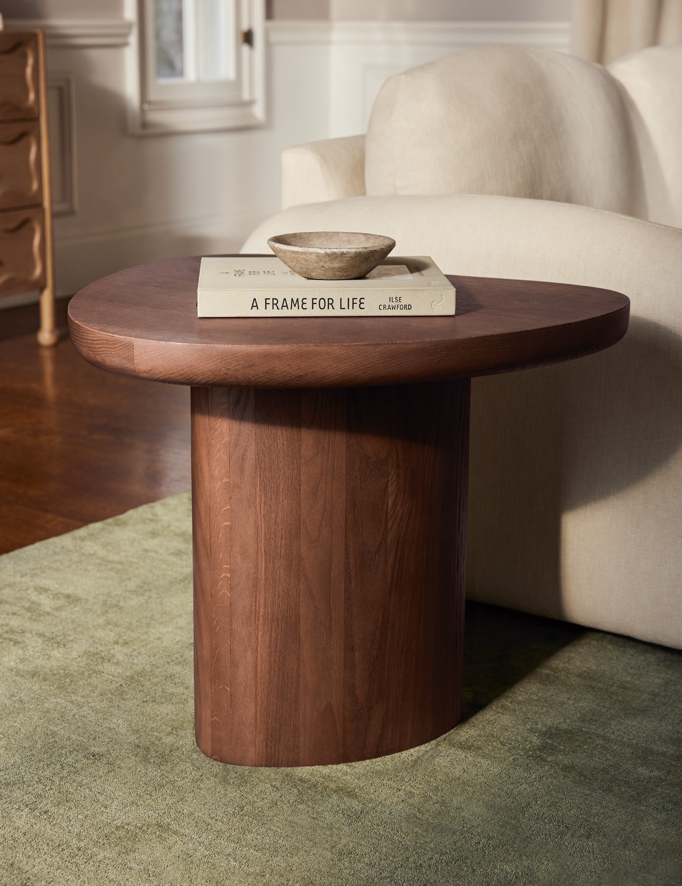 Torino sculptural dark brown nesting coffee table by Aimee Song styled as a side table