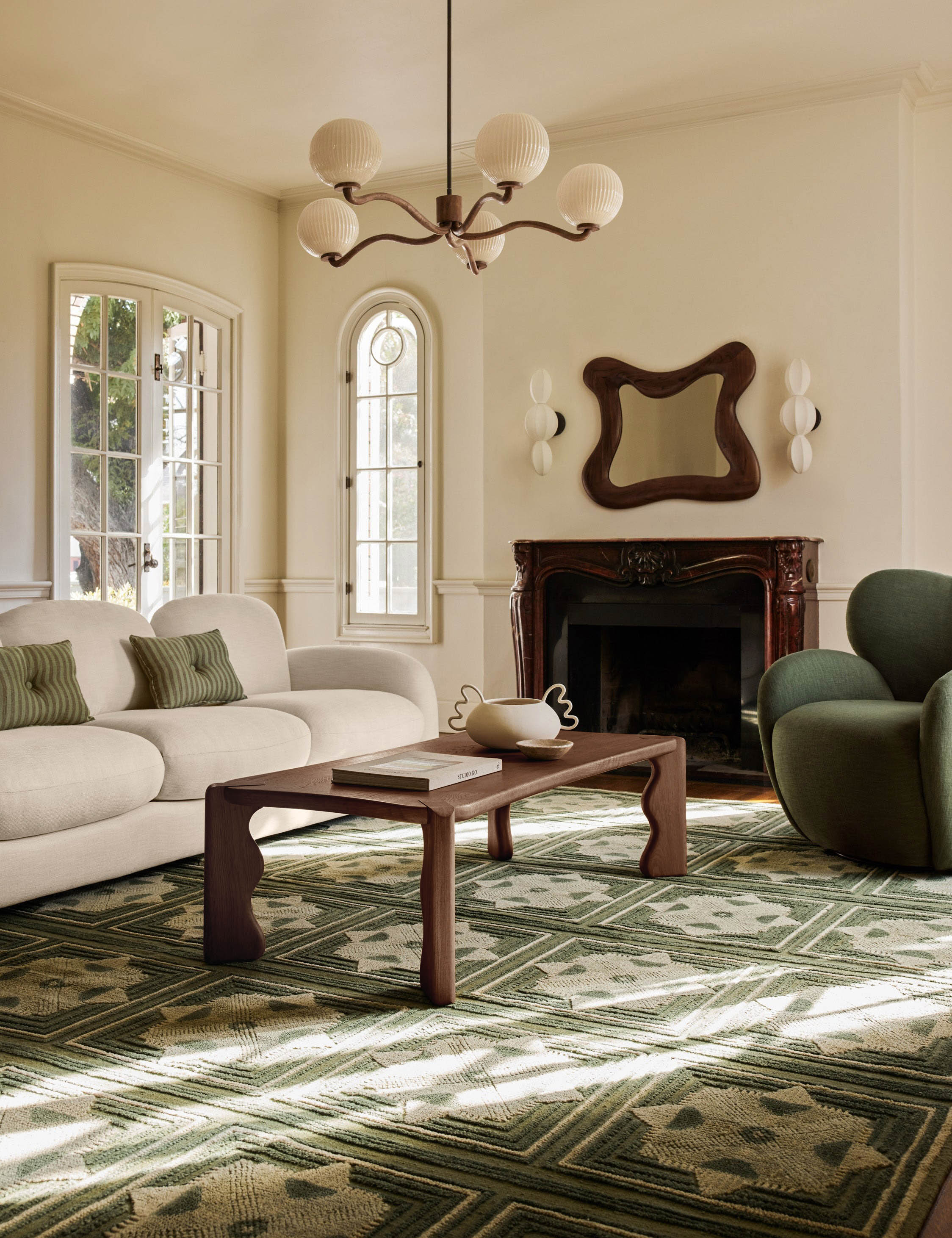 Nara fluted glass 5-globe chandelier by Aimee Song hanging in a living room