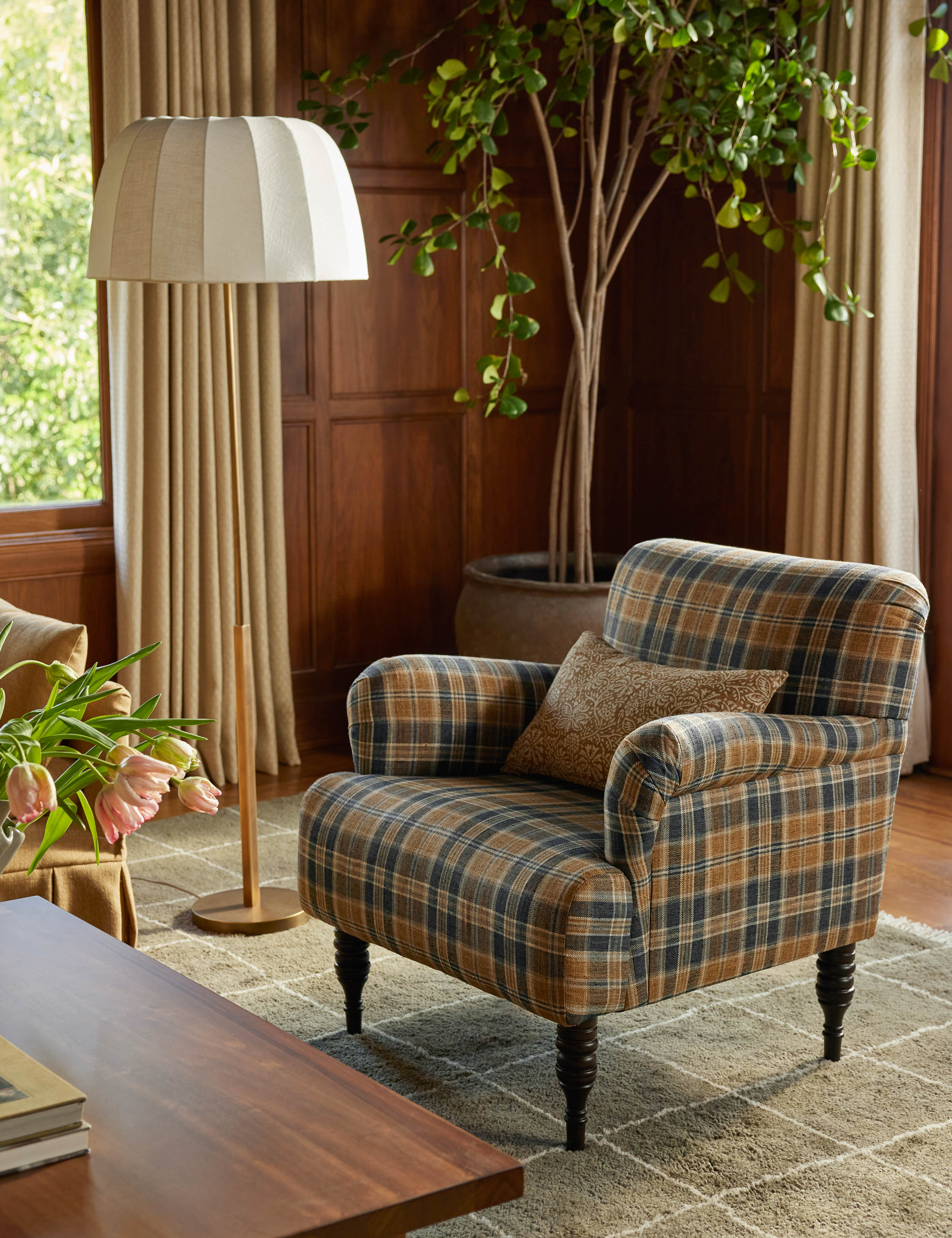 Ebele slim frame, linen shade floor lamp styled next to a plaid accent chair