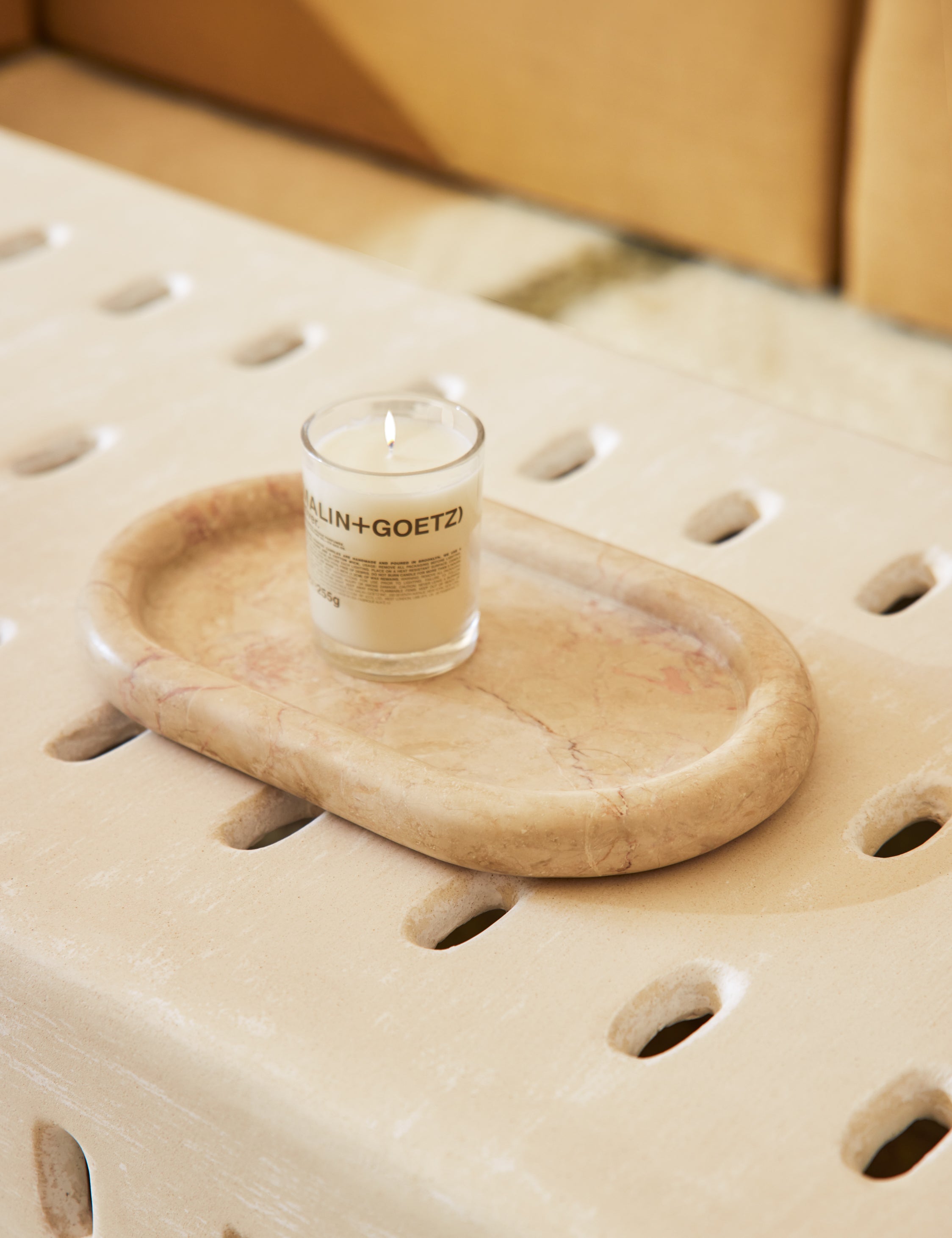 Besser marble oval tray styled on a coffee table with a candle.