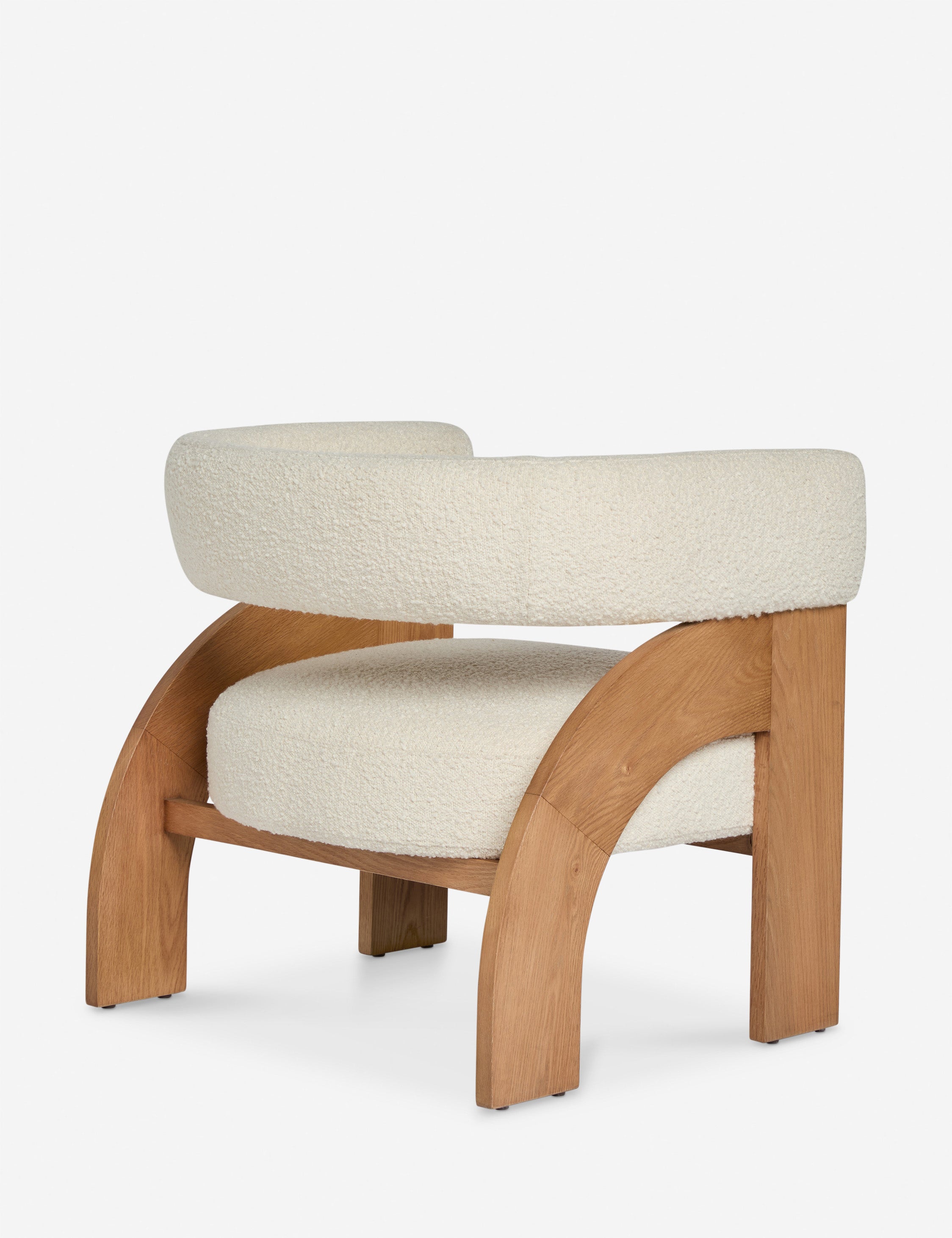 Angled back view of the Agacia barrel back boucle upholstered accent chair by Aimee Song