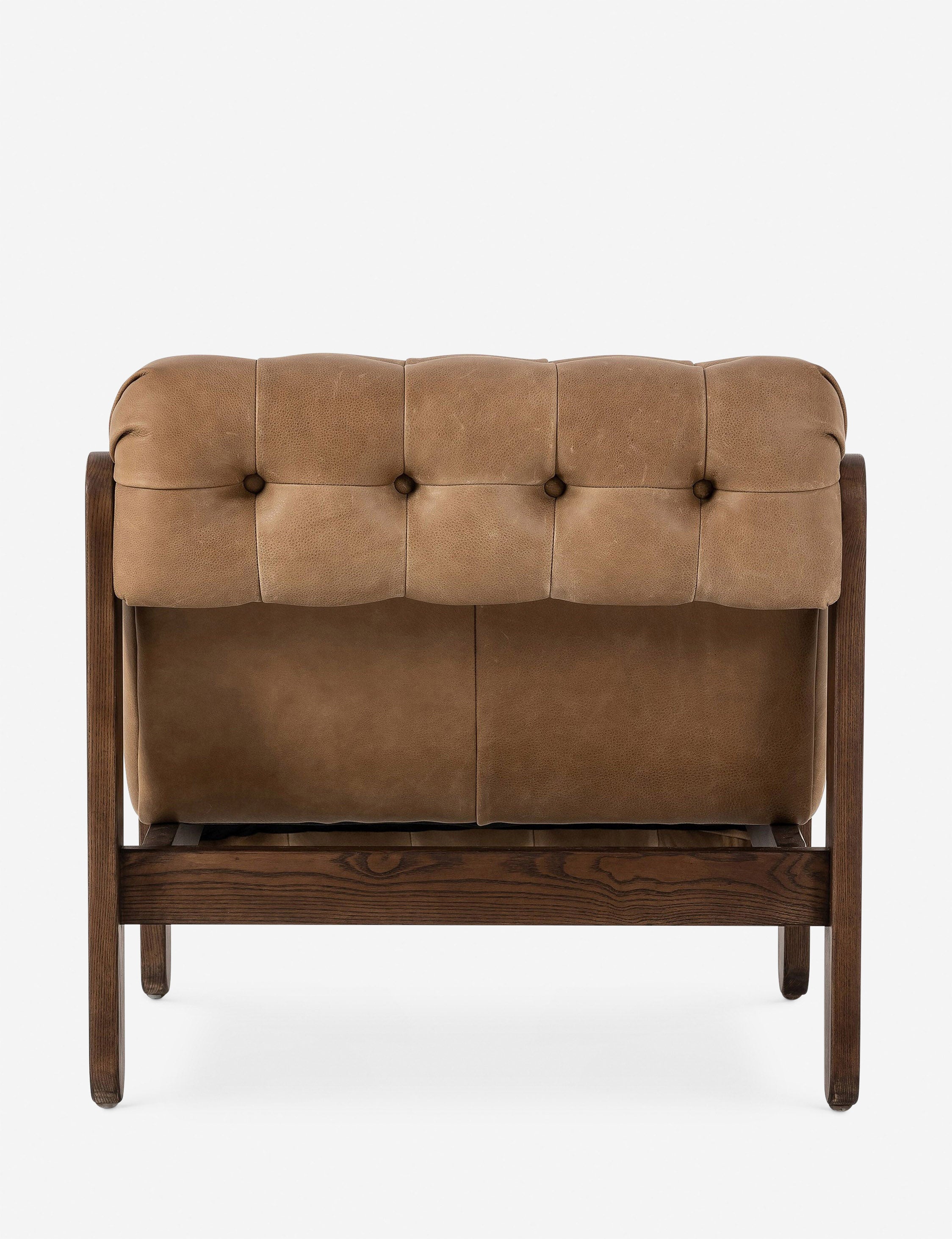 Cantor button-tufted armless leather accent chair.