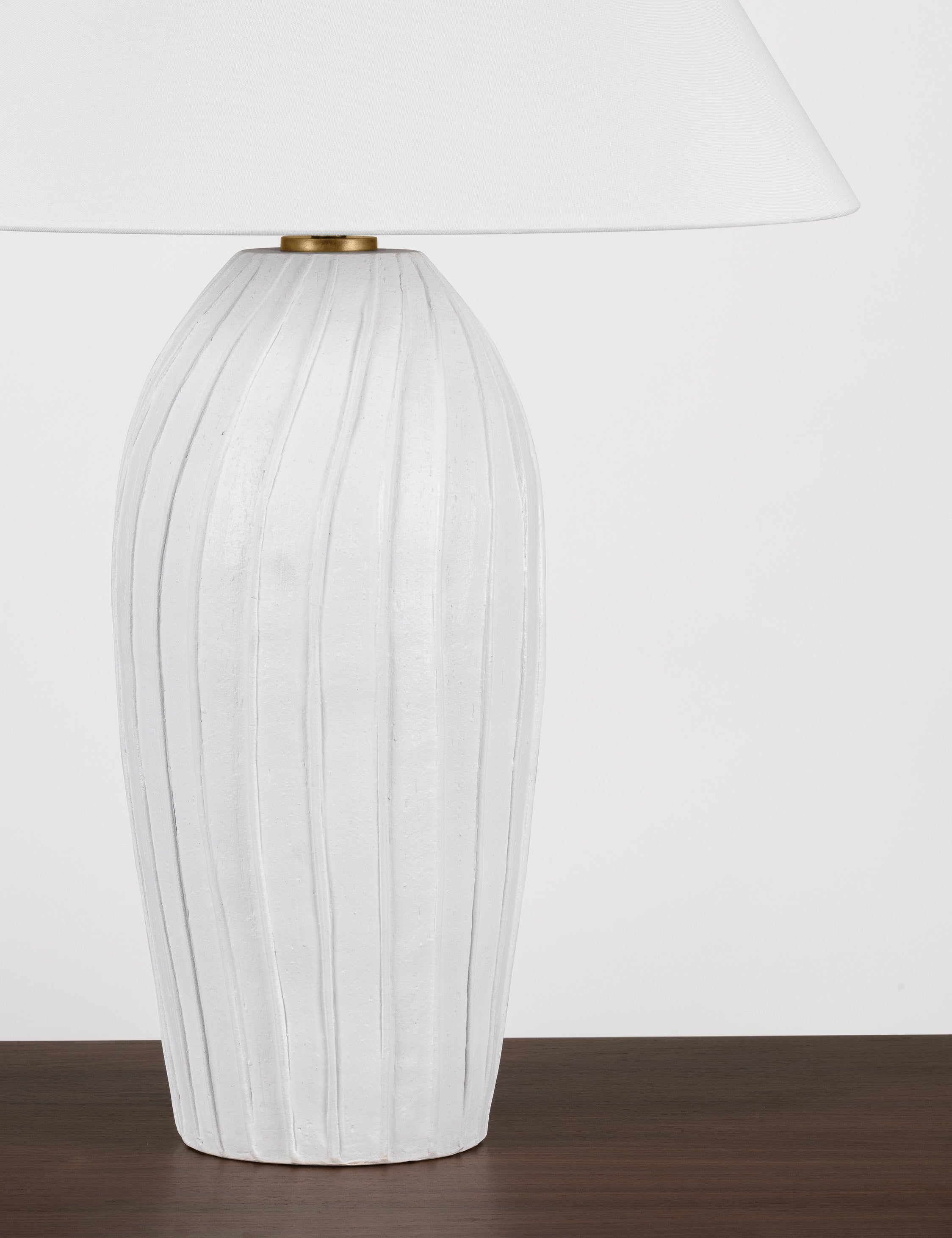 Close up of the base of the Pama sculptural, pleated-detail ceramic table lamp