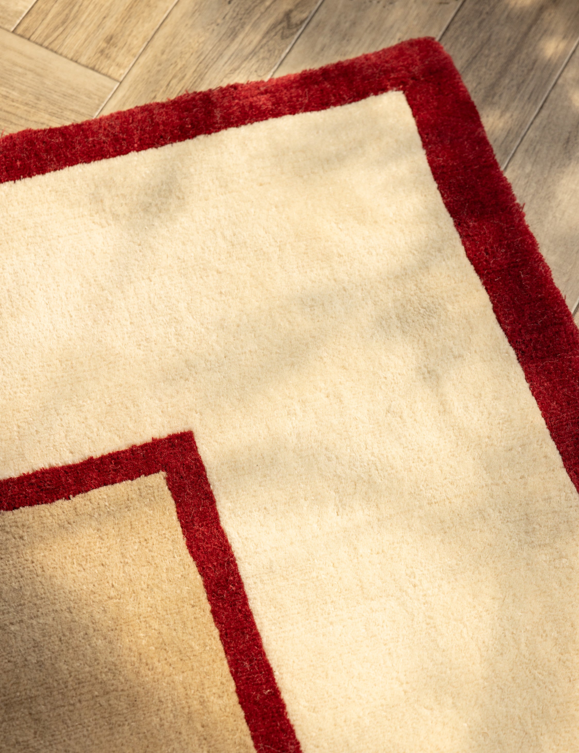 Close up of the corner of the Deller Hand-Loomed Wool Rug by Jake Arnold