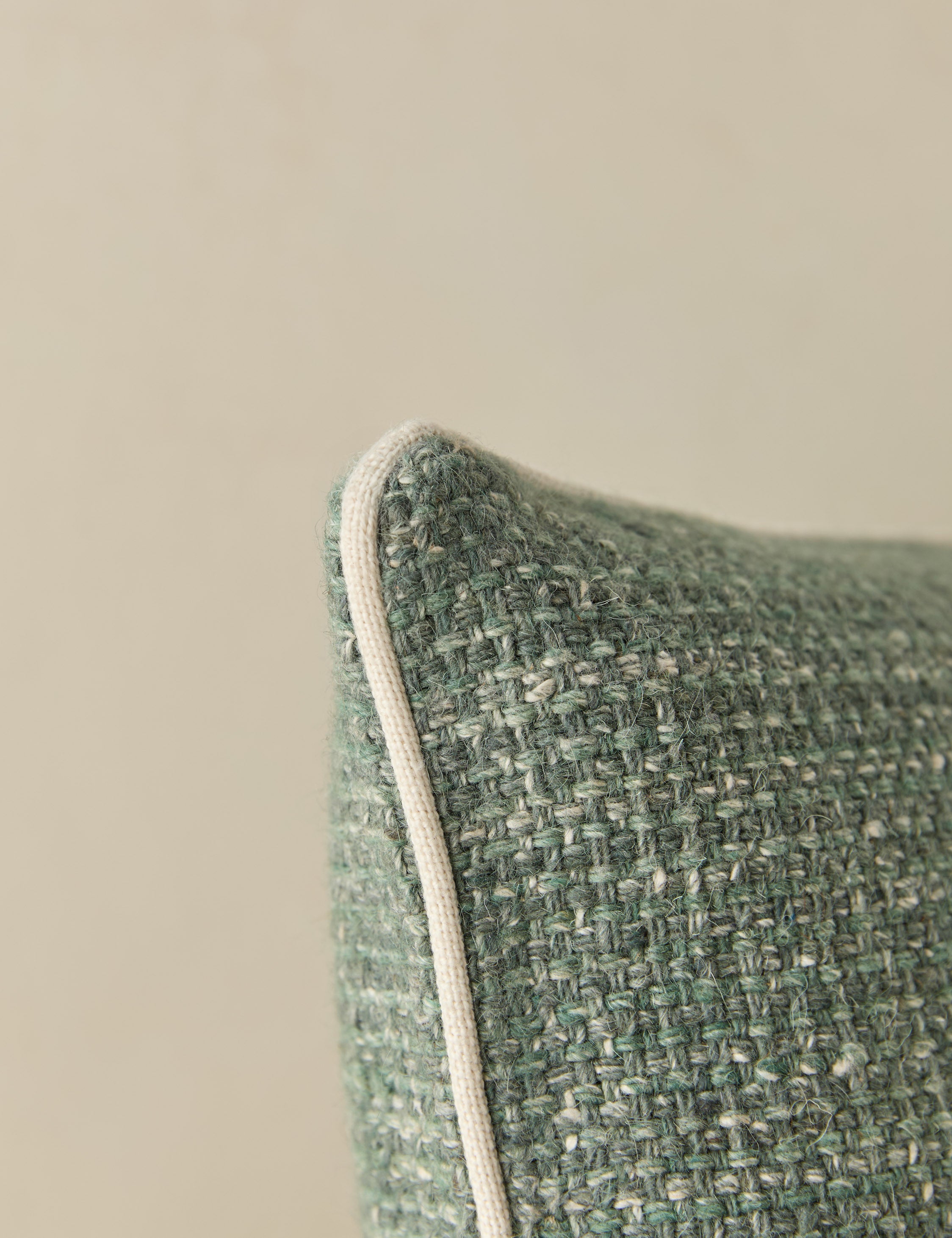 Close up view of the corner of the Enzi tactile tweed pillow by Aimee Song
