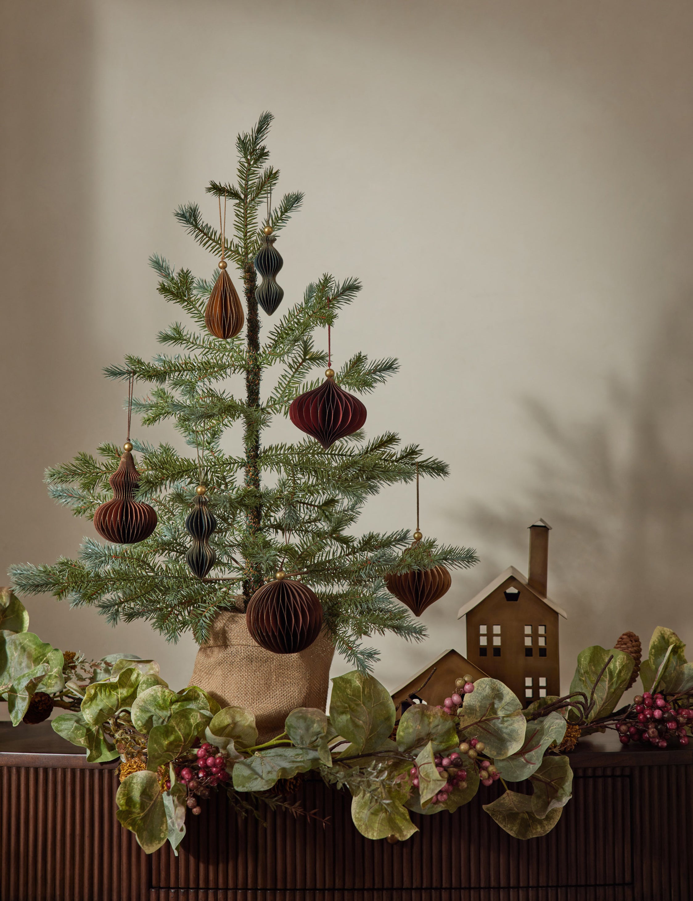 Faux spruce tree with burlap sack