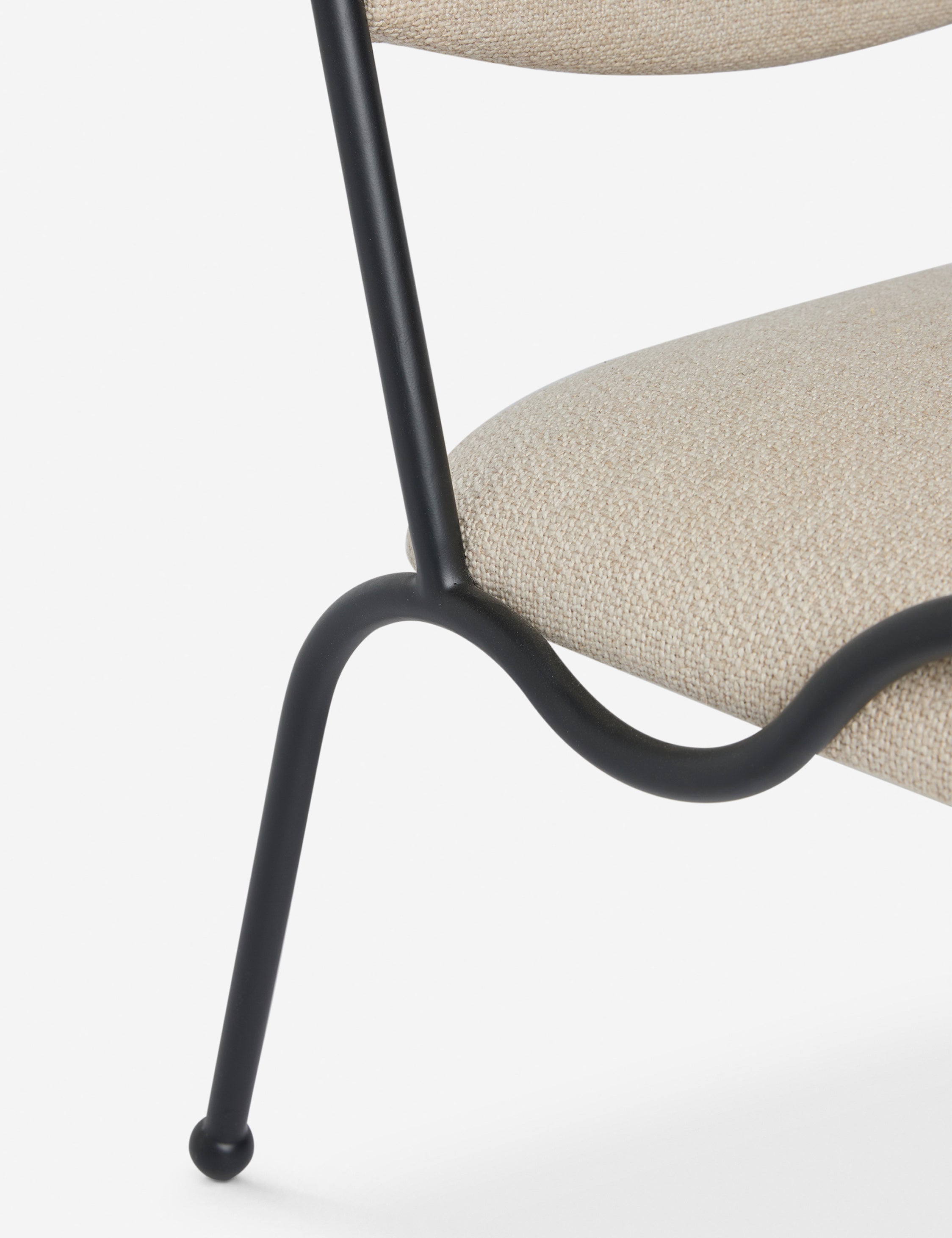 Close up view of the Fidia curved metal silhouette accent chair by Aimee Song